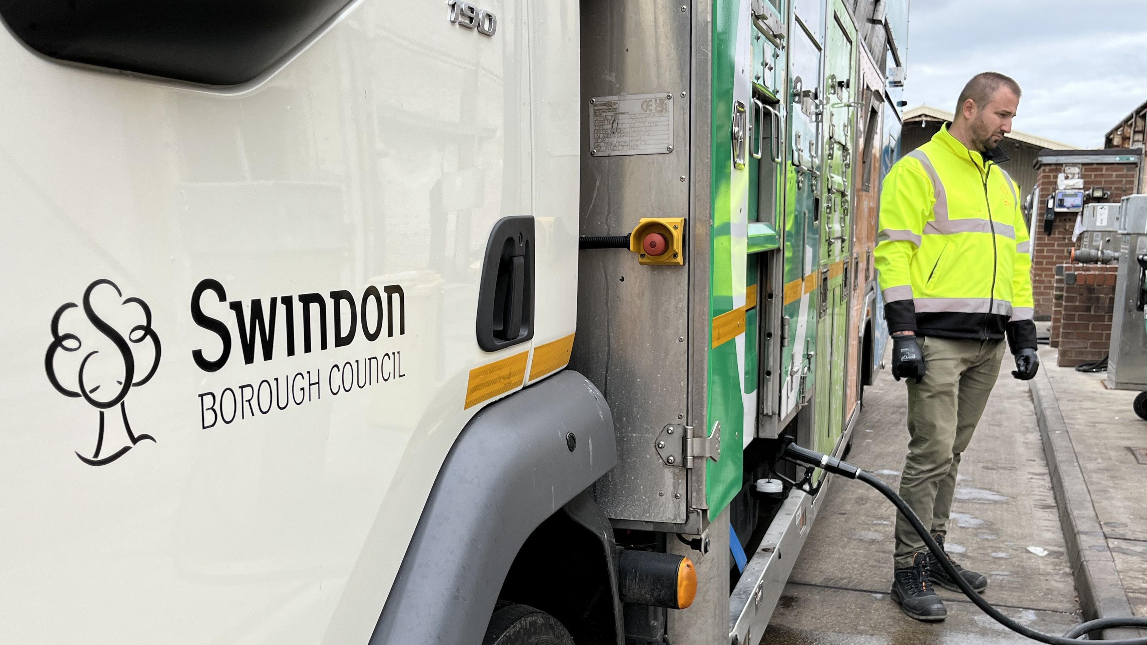 Swindon Borough Council logo on the side of a recycling truck that's being refuelled