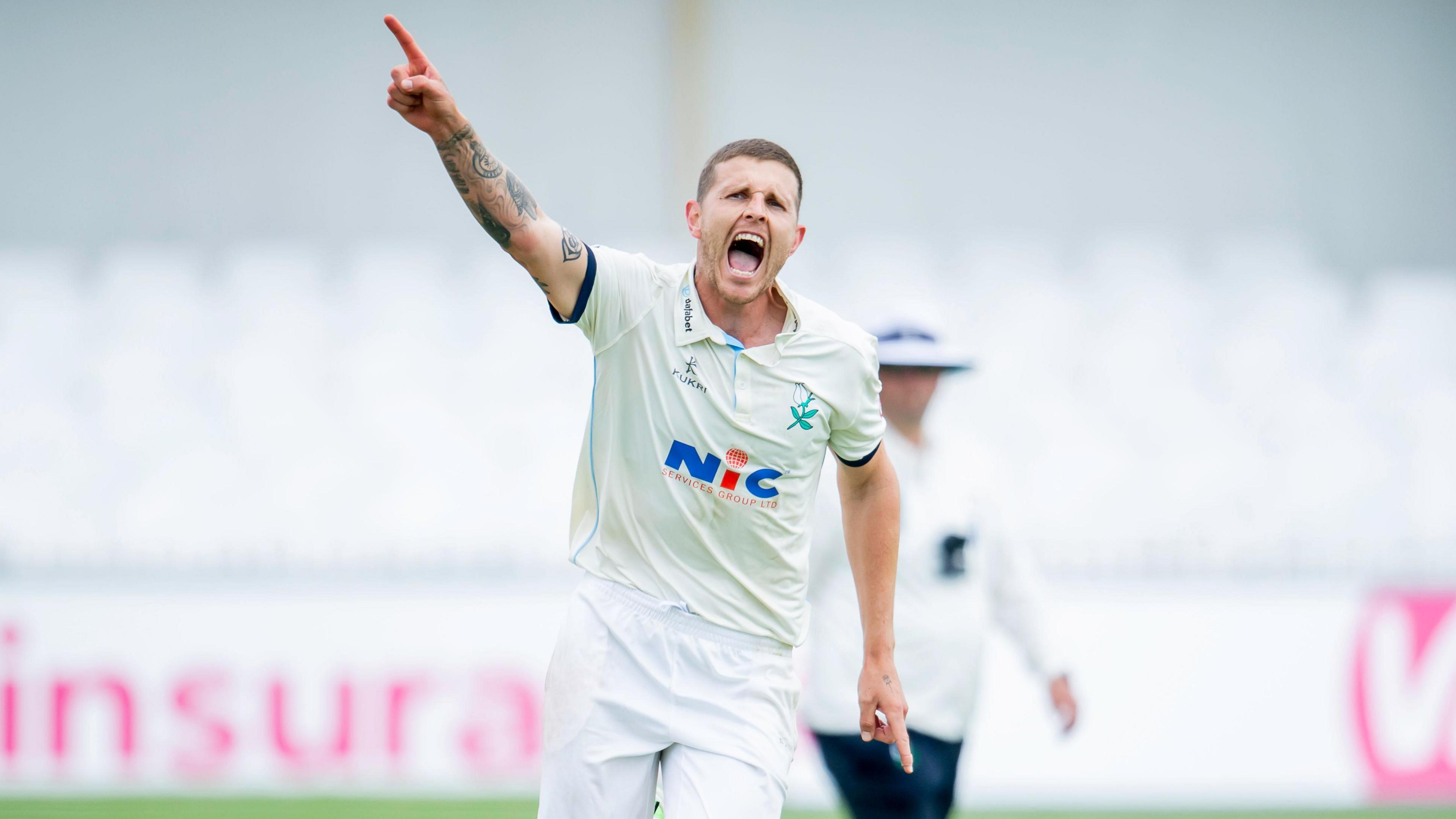 Conor McKerr celebrates taking a wicket for Yorkshire 