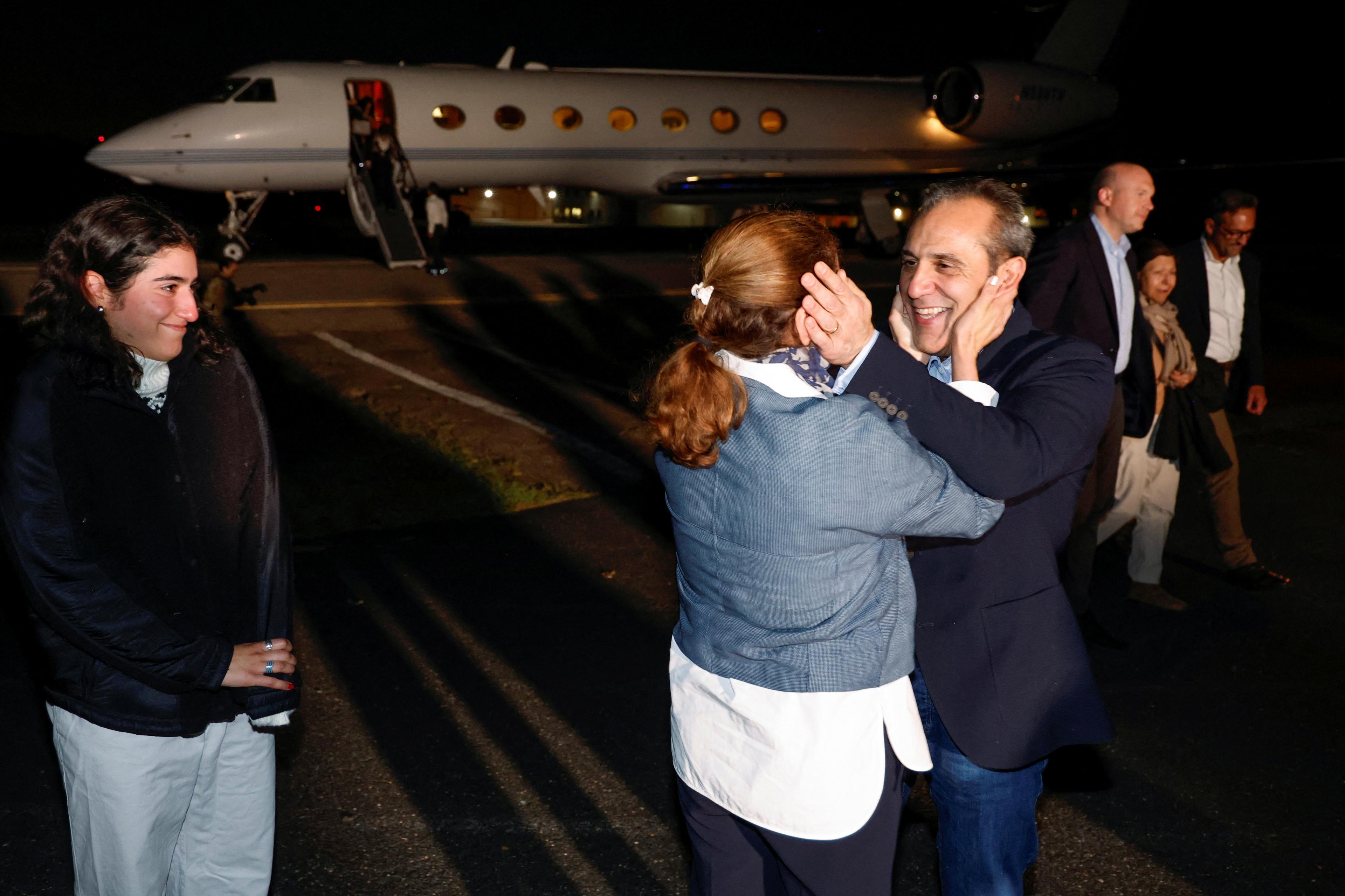 Freed American Emad Shargi embraces his wife after he and four fellow detainees were released in a prisoner swap deal between U.S and Iran.