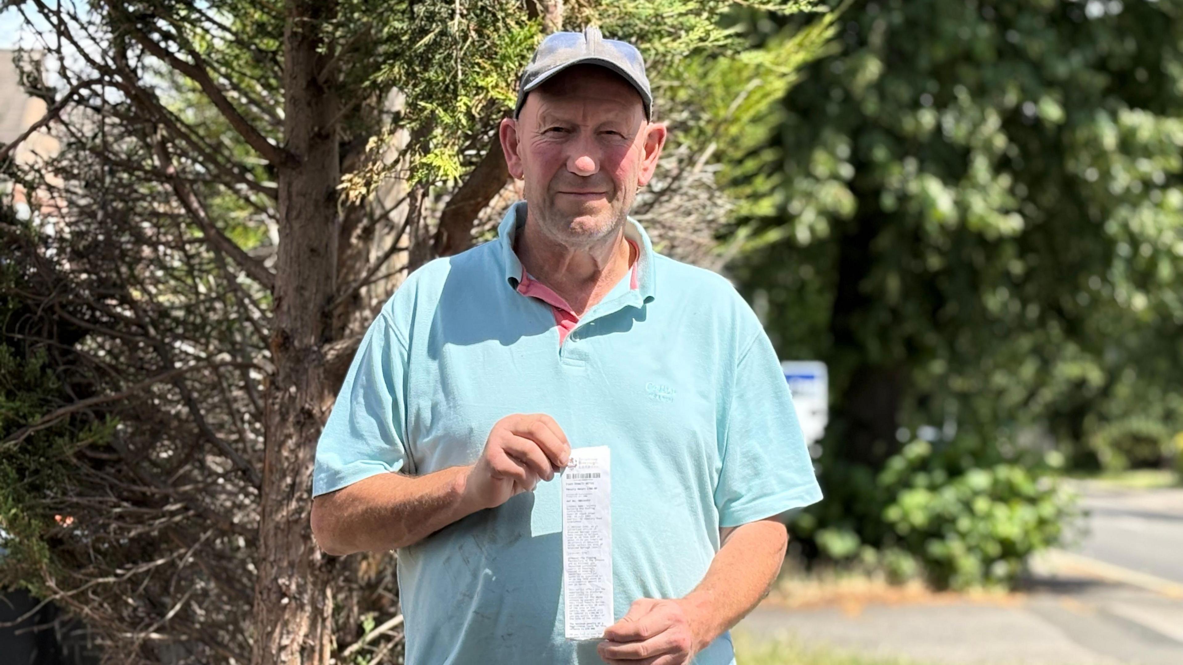 Frank Brown holding the fixed penalty notice