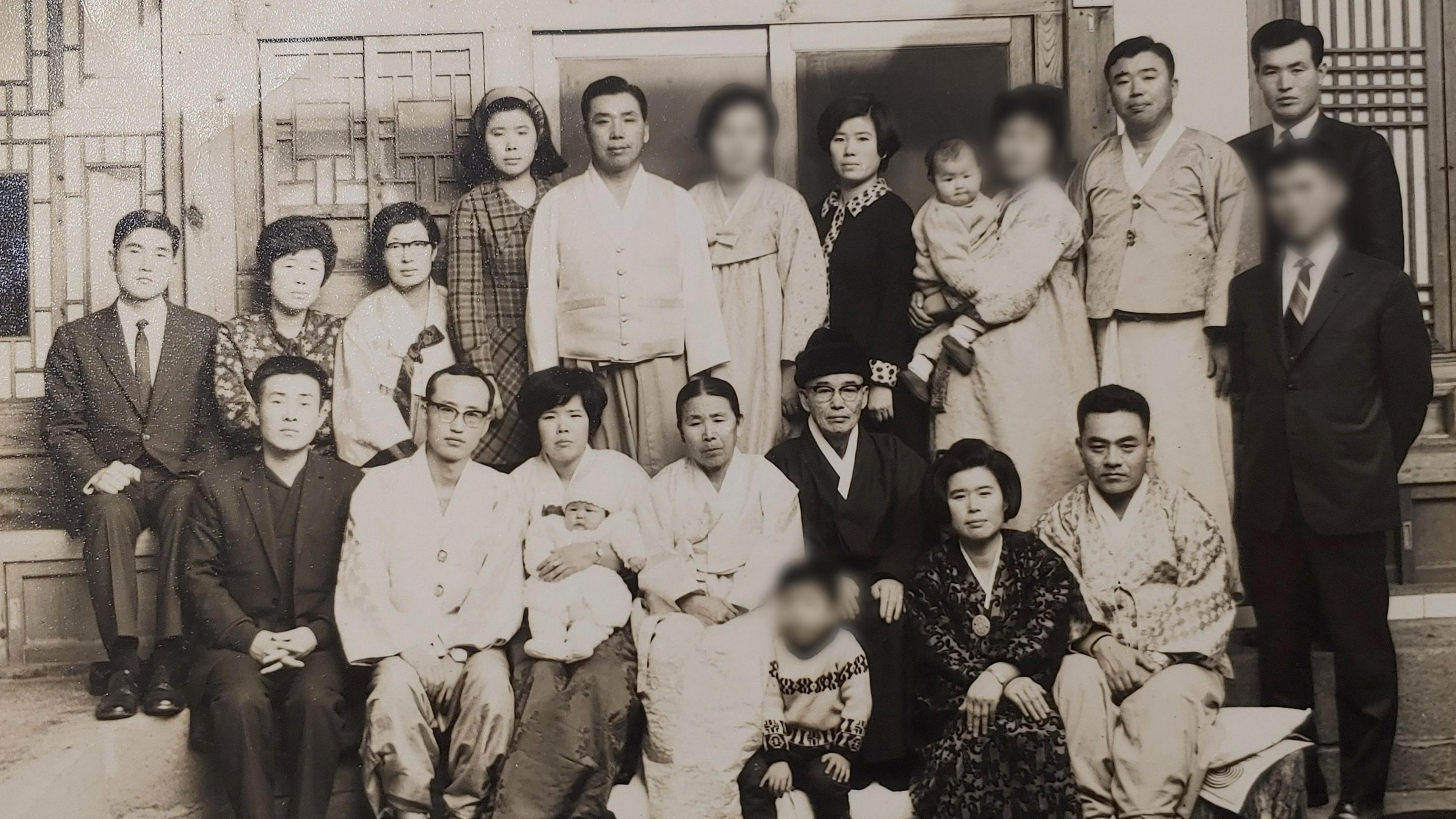 A black and white family photo of Kim Jae-gyu