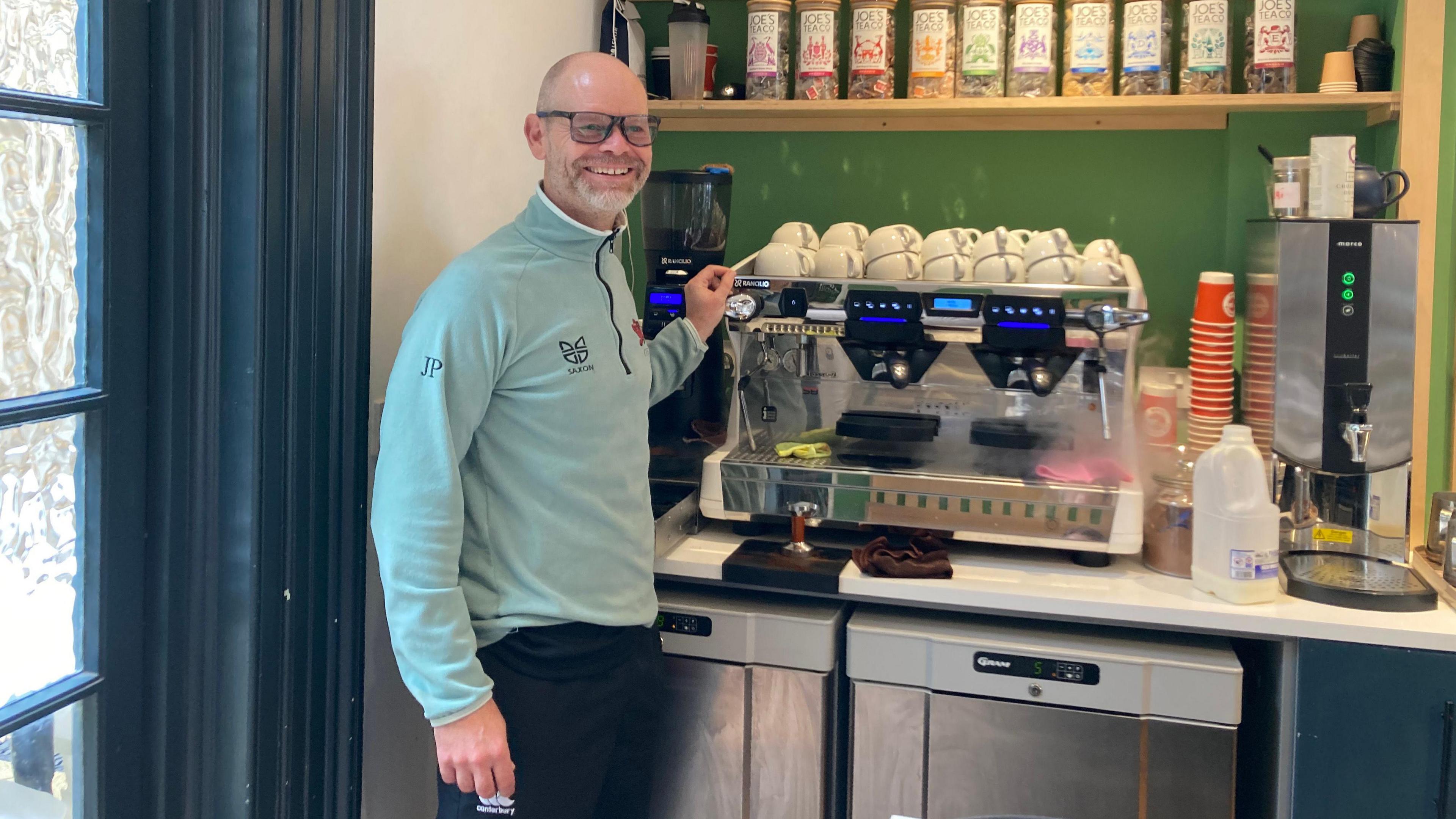 James Powley standing in front of a coffee machine making coffee