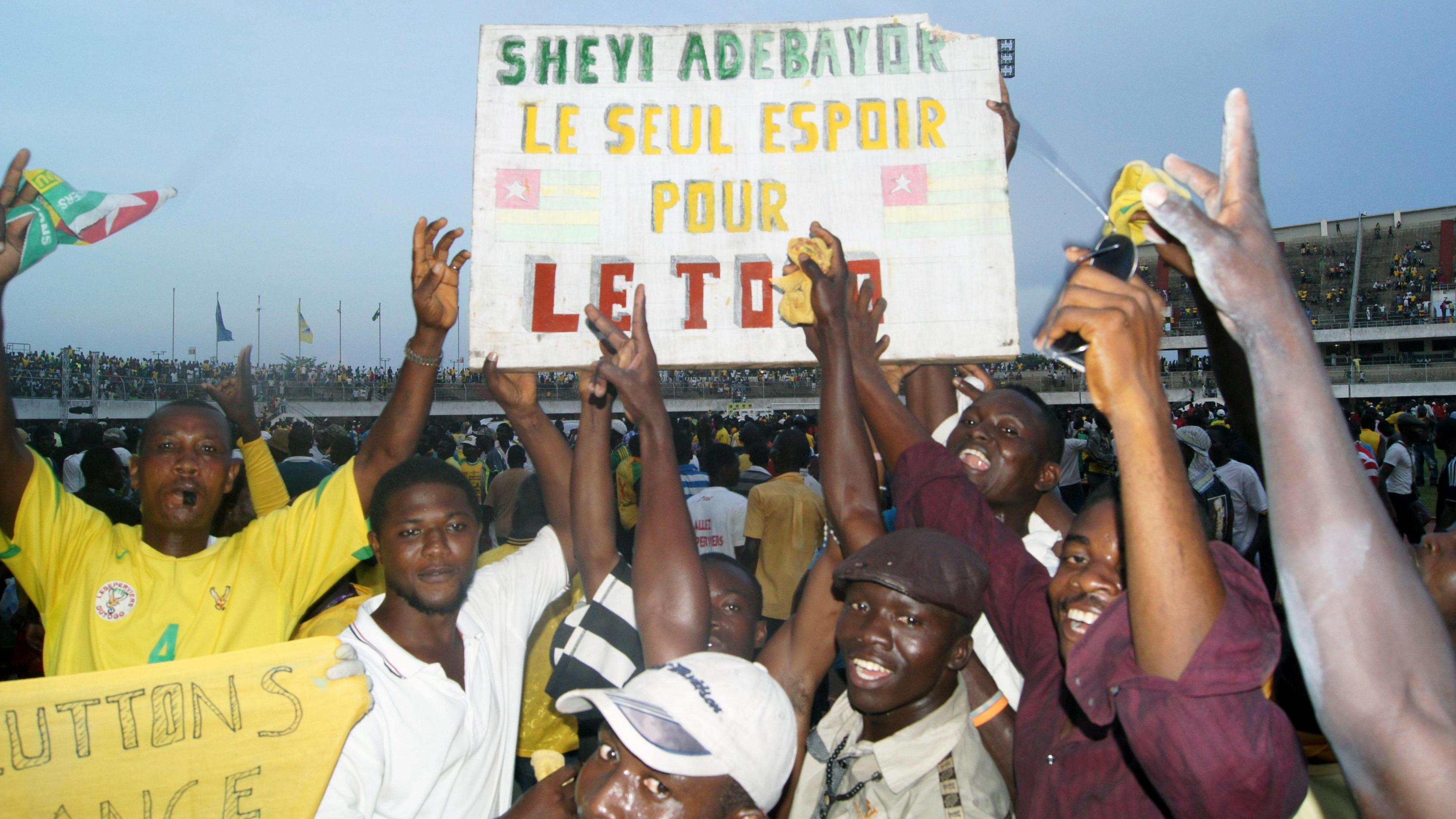 Togo supporters hold a placard in French, translating as 'Sheyi Adebayor, Togo's only hope' as they celebrate at the end of an Africa Cup of Nations qualifier in Lome in 2012