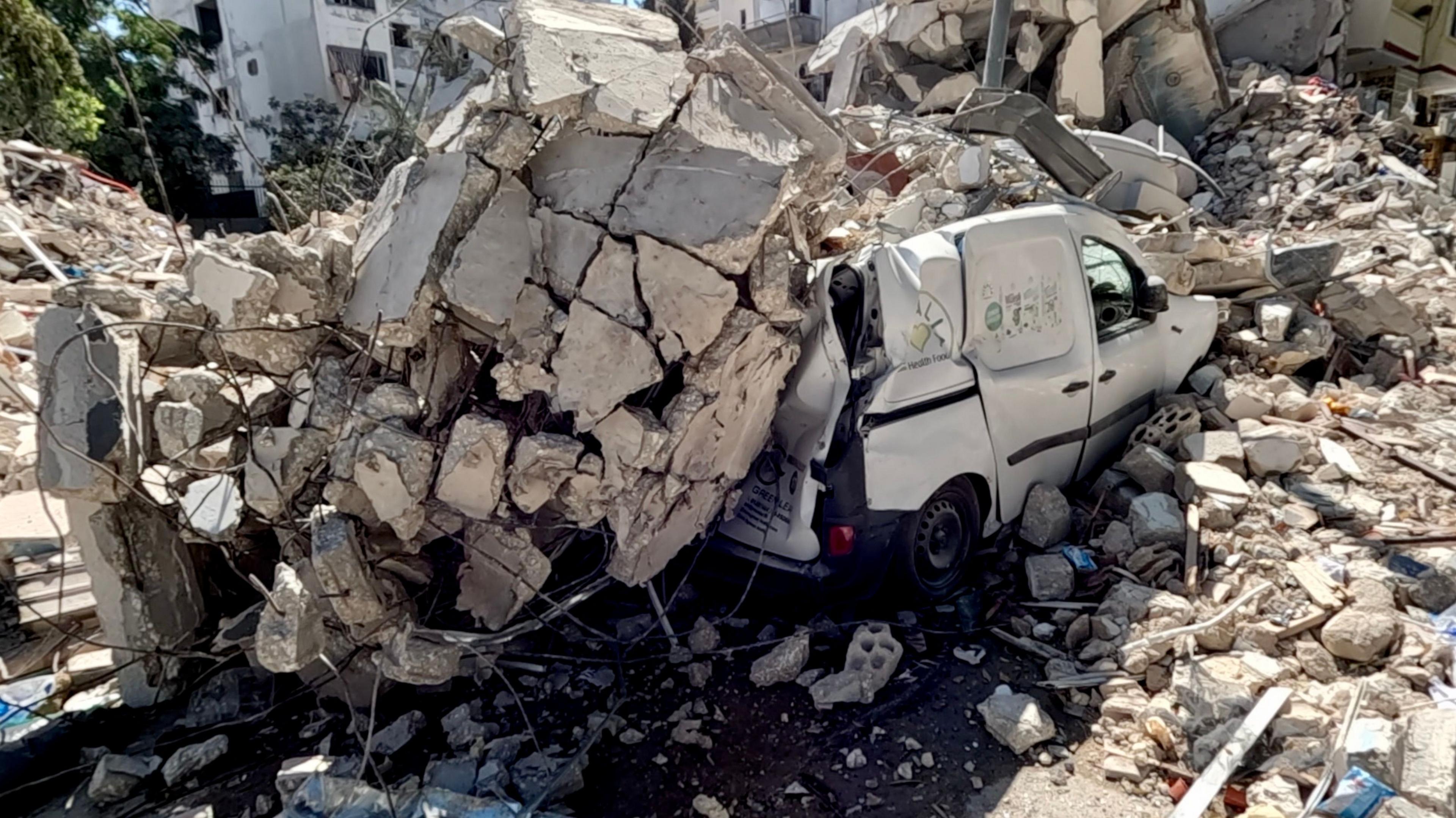 A vehicle crushed under rubble