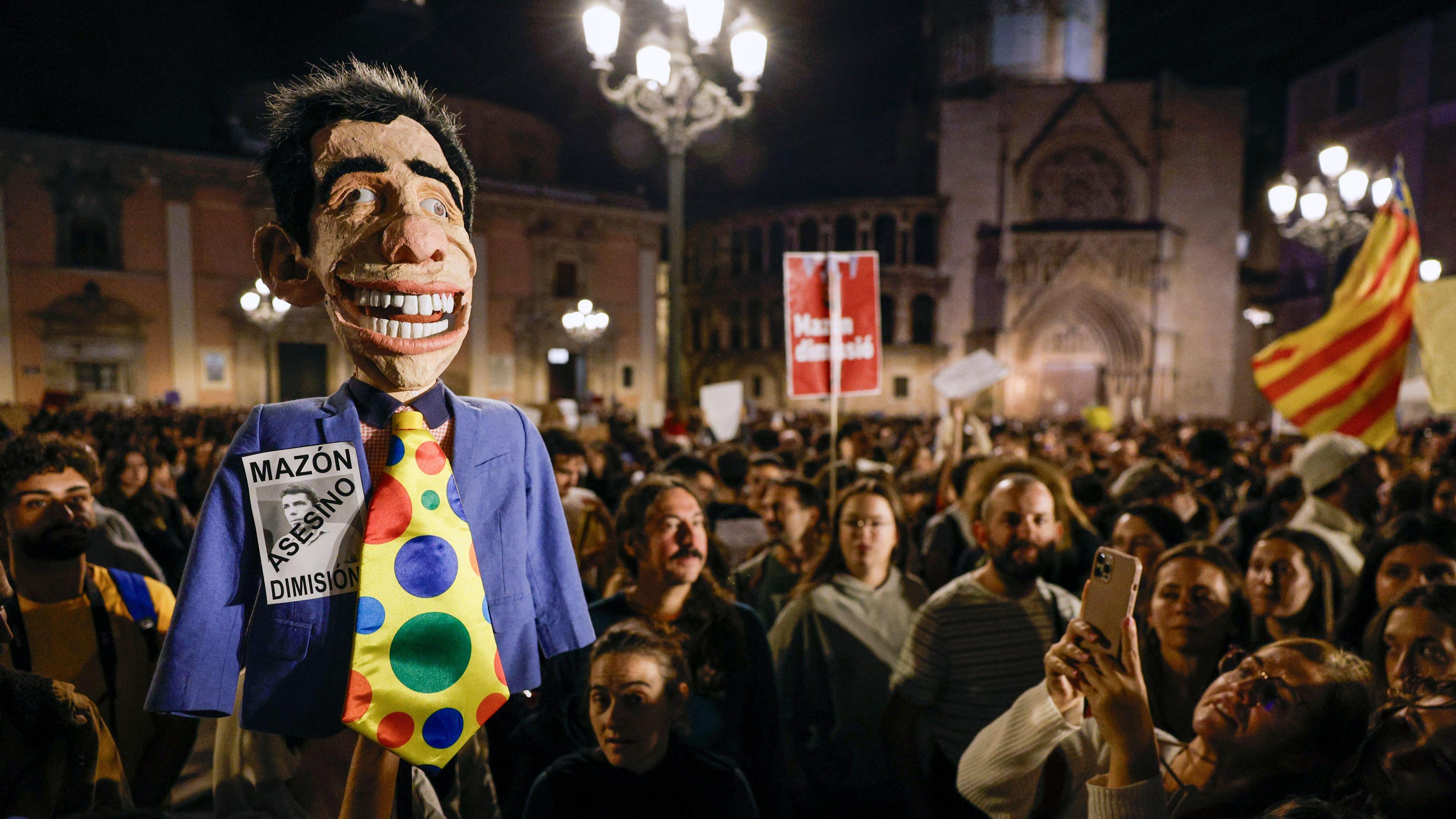 A person holds a doll depicting Valencia's Regional President Carlos Mazon as thousands of people take part in a protest to call for the resignation of Valencia's regional government due to the management of the floods in Valencia province, in Valencia, Spain, 09 November 2024.