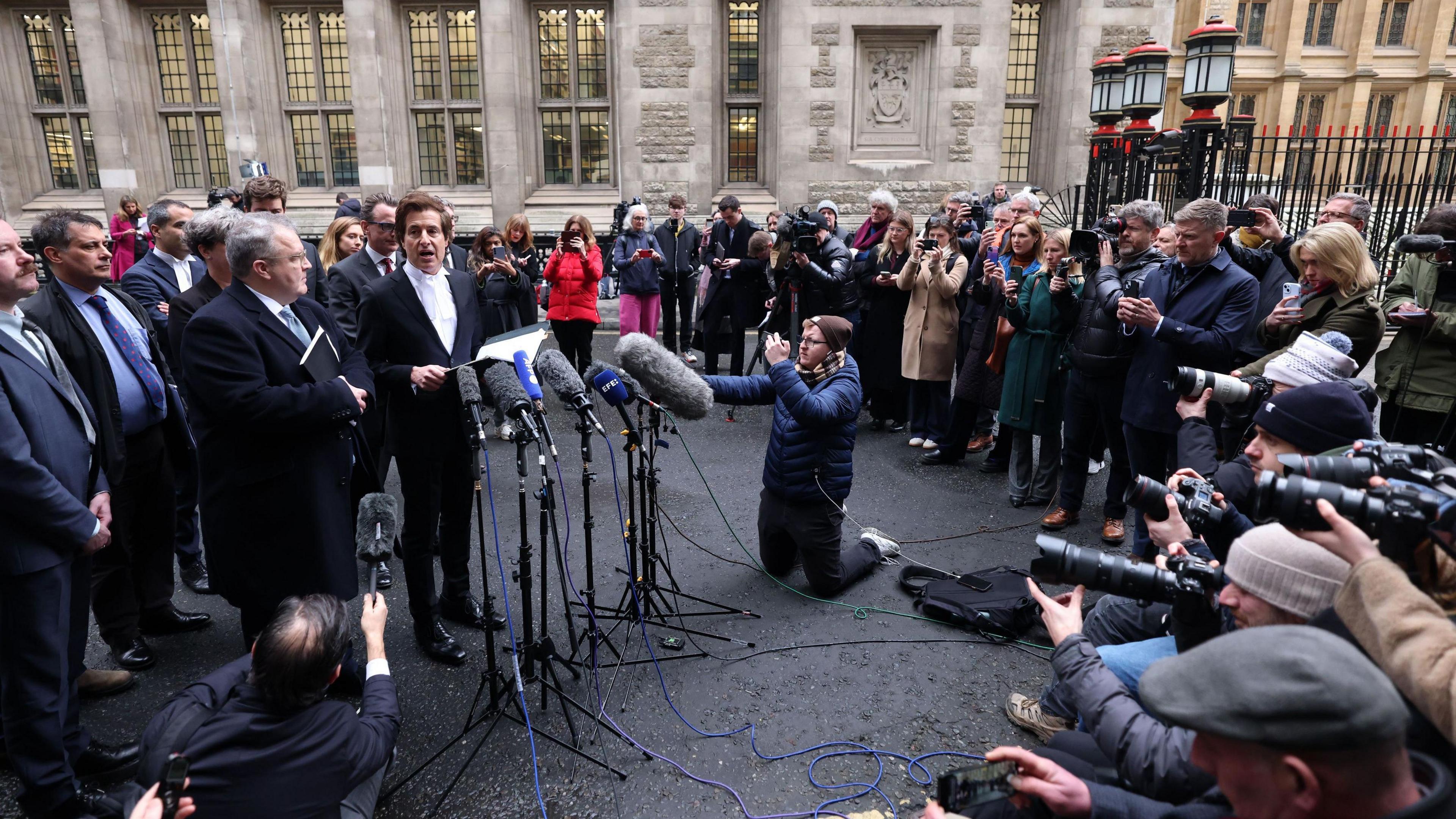 Media gathered outside the court to hear David Sherborne reading out a statement