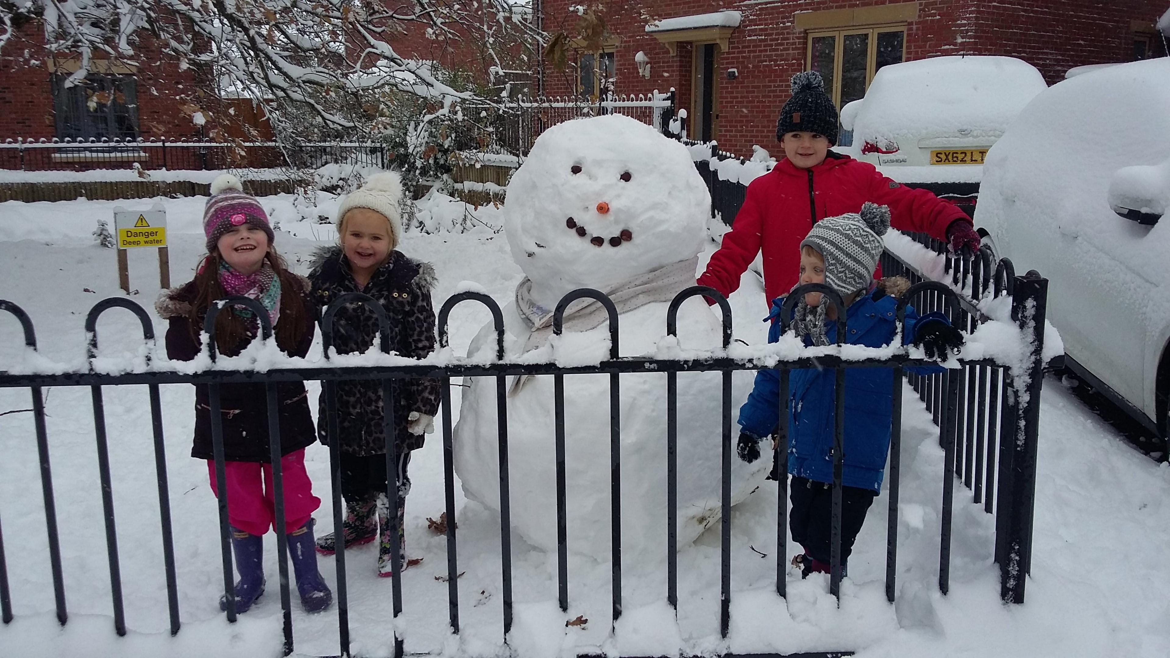 Four children with snowman