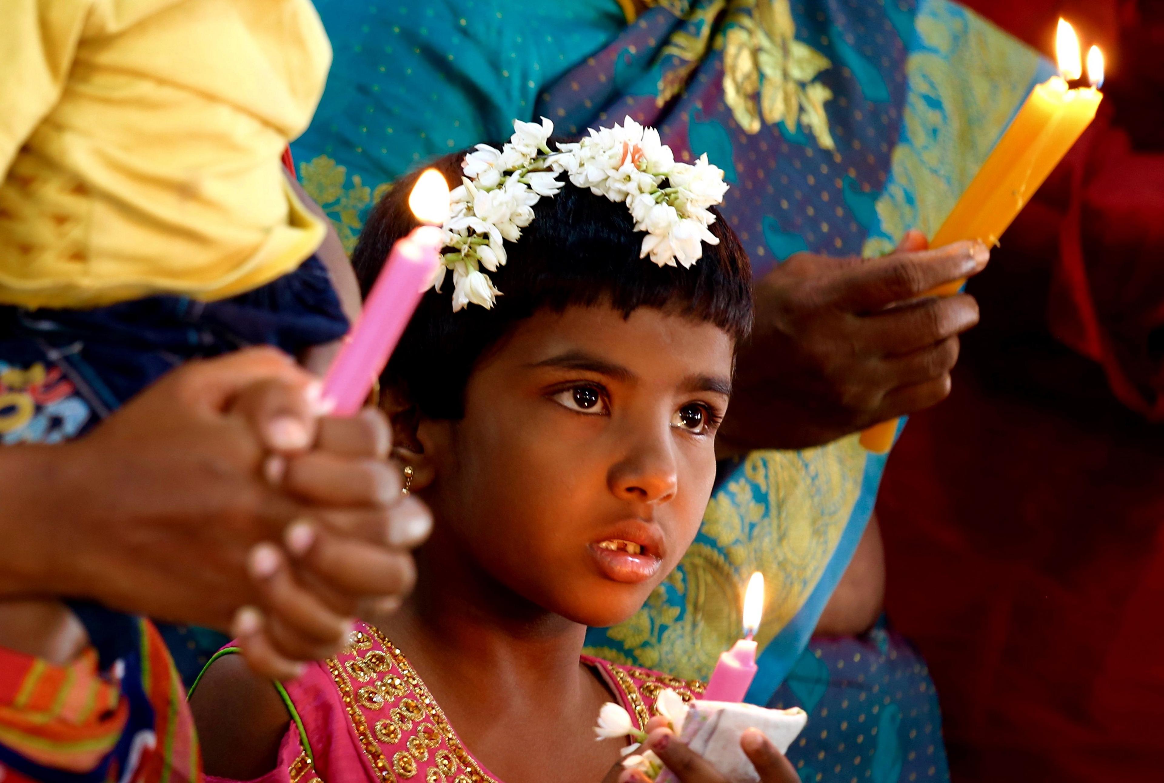 Indian Christians taking part in Christmas prayers at the Infant Jesus church in Bangalore, India