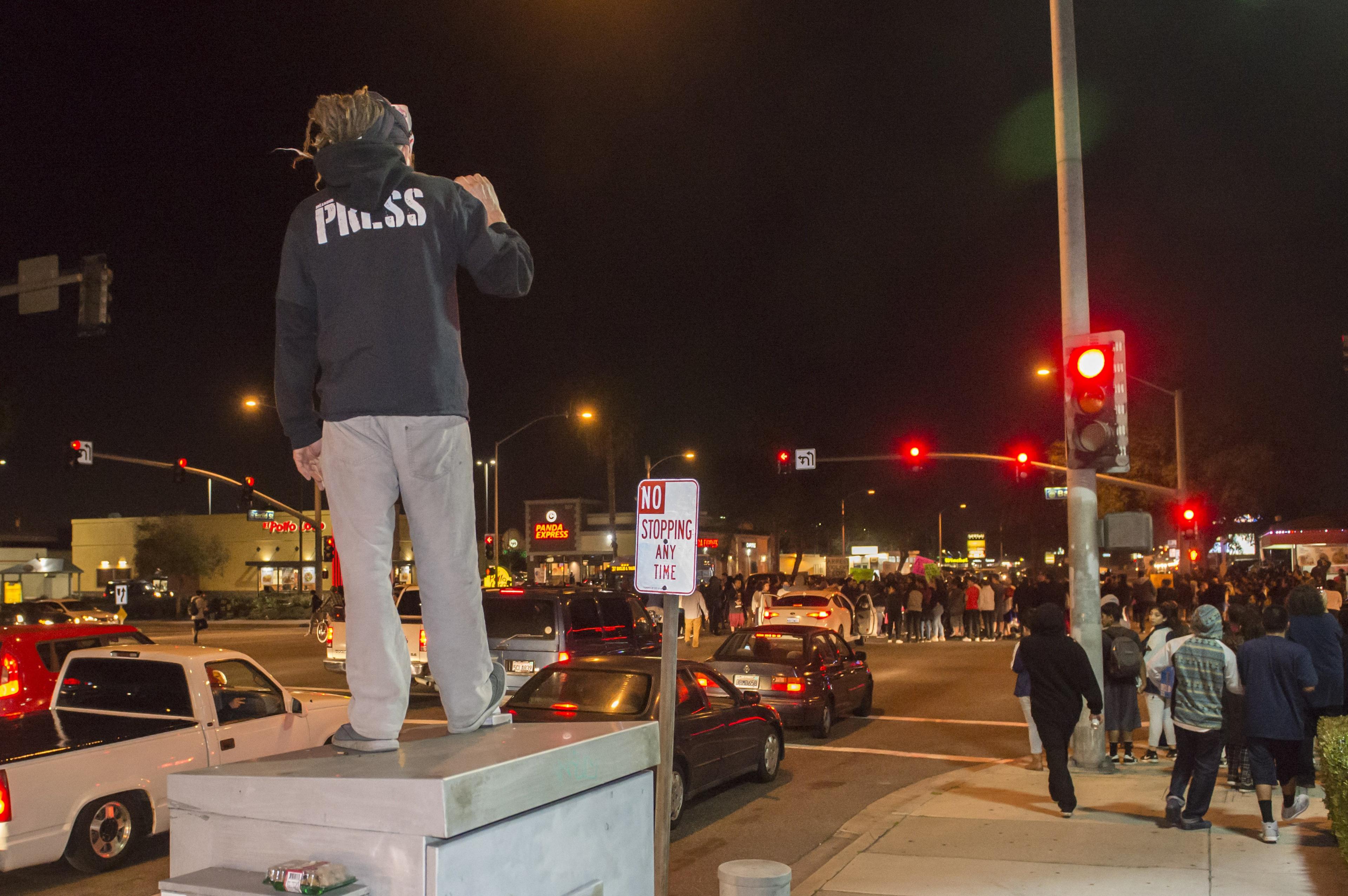 Protesters took to Euclid Street, blocking traffic and marching north toward Ball Road, where they congregated in the intersection for several minutes in Anaheim, Calif., Wednesday, 22 Feb 2017