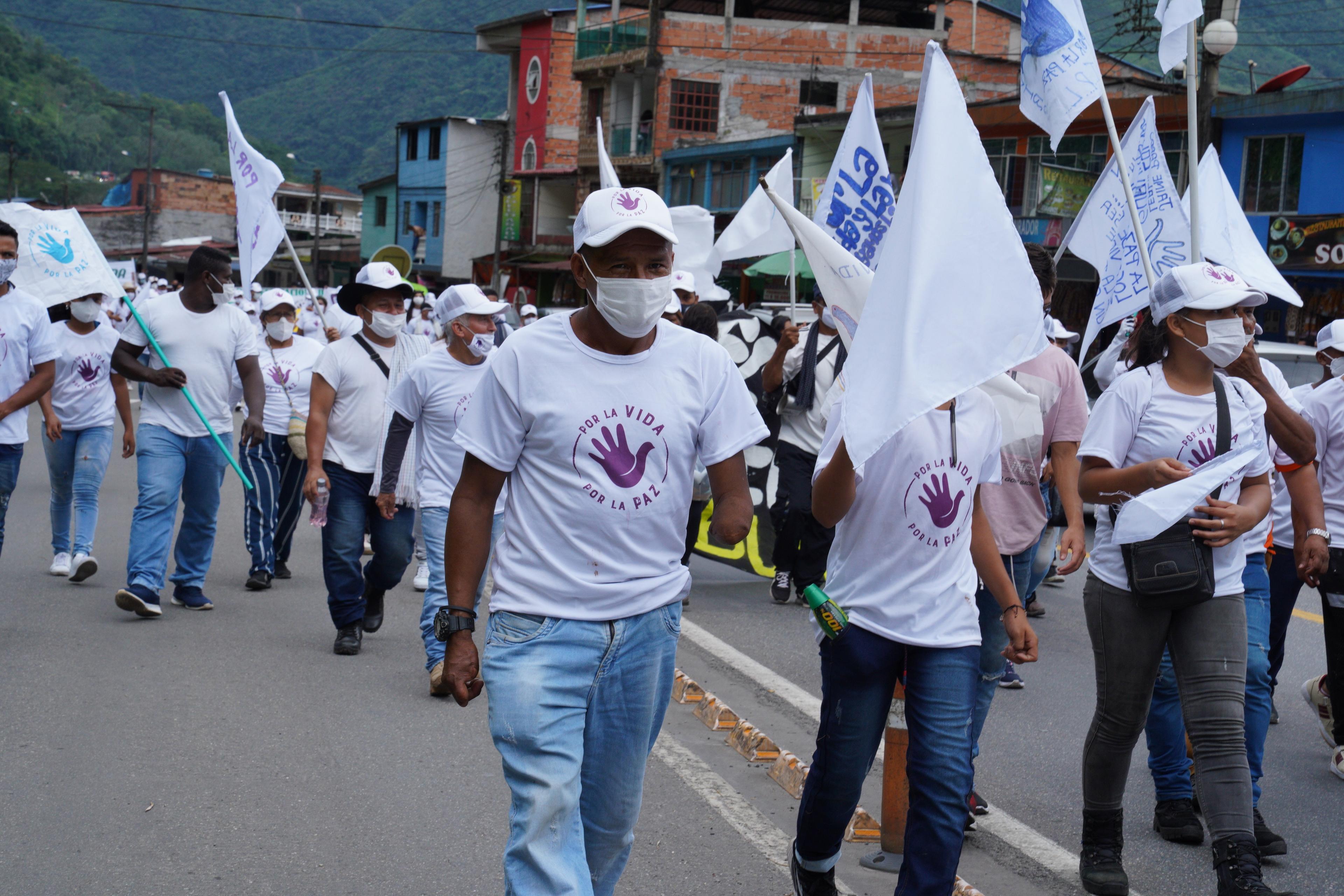 A group of former Farc fighters from the provinces of Meta and Guaviare march through the small town of Guayabetal, Colombia on Oct 31.