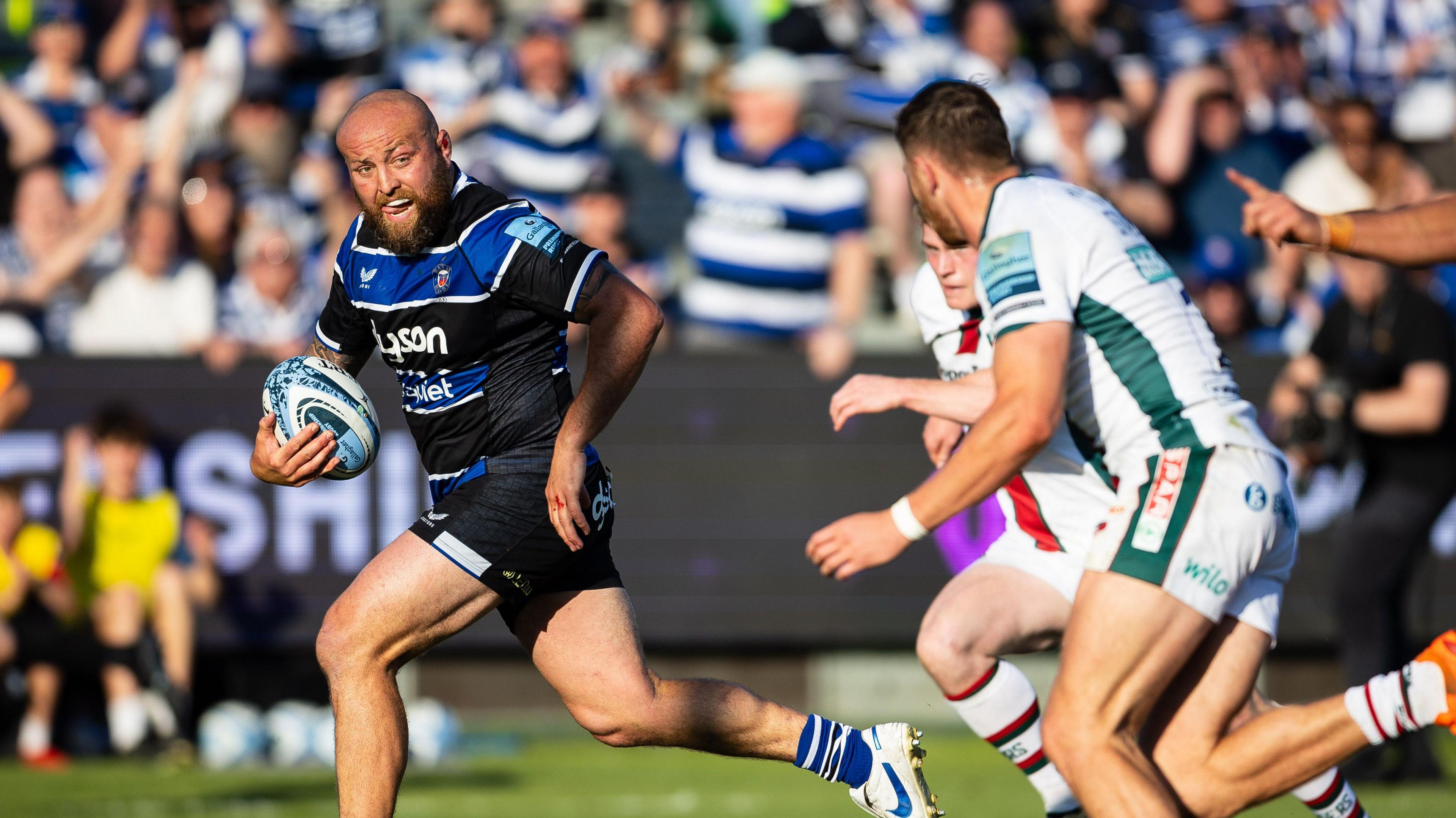 Tom Dunn (left) running with the ball during Bath's win against Leicester