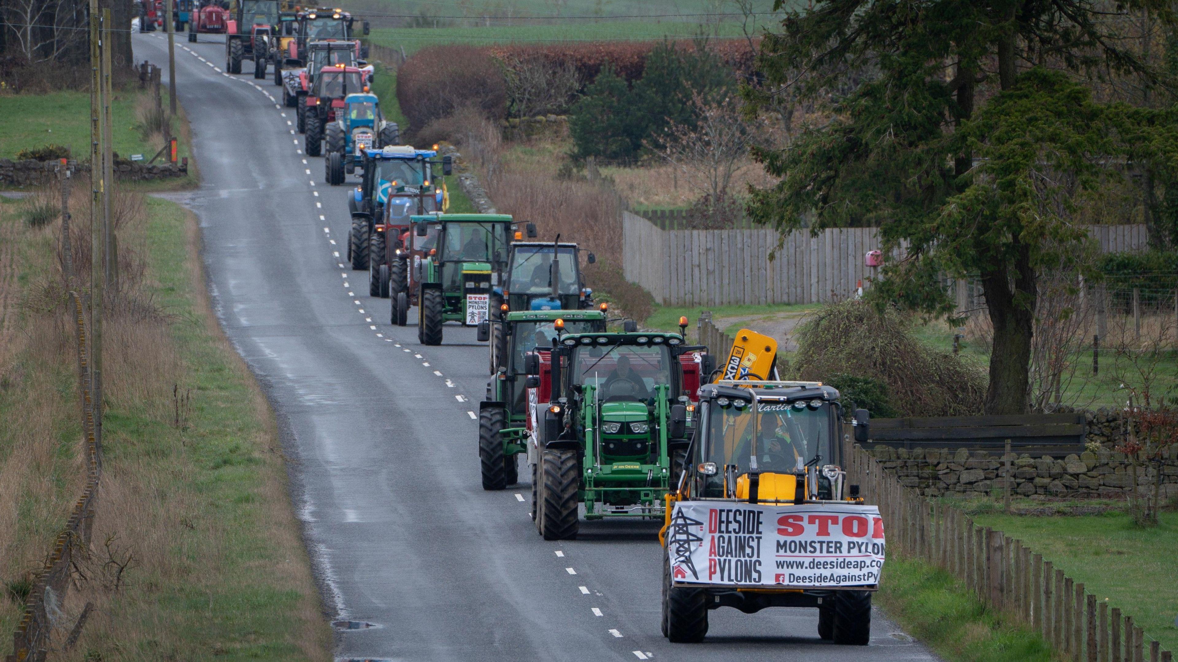 Protesting tractors being driven along pylon route 