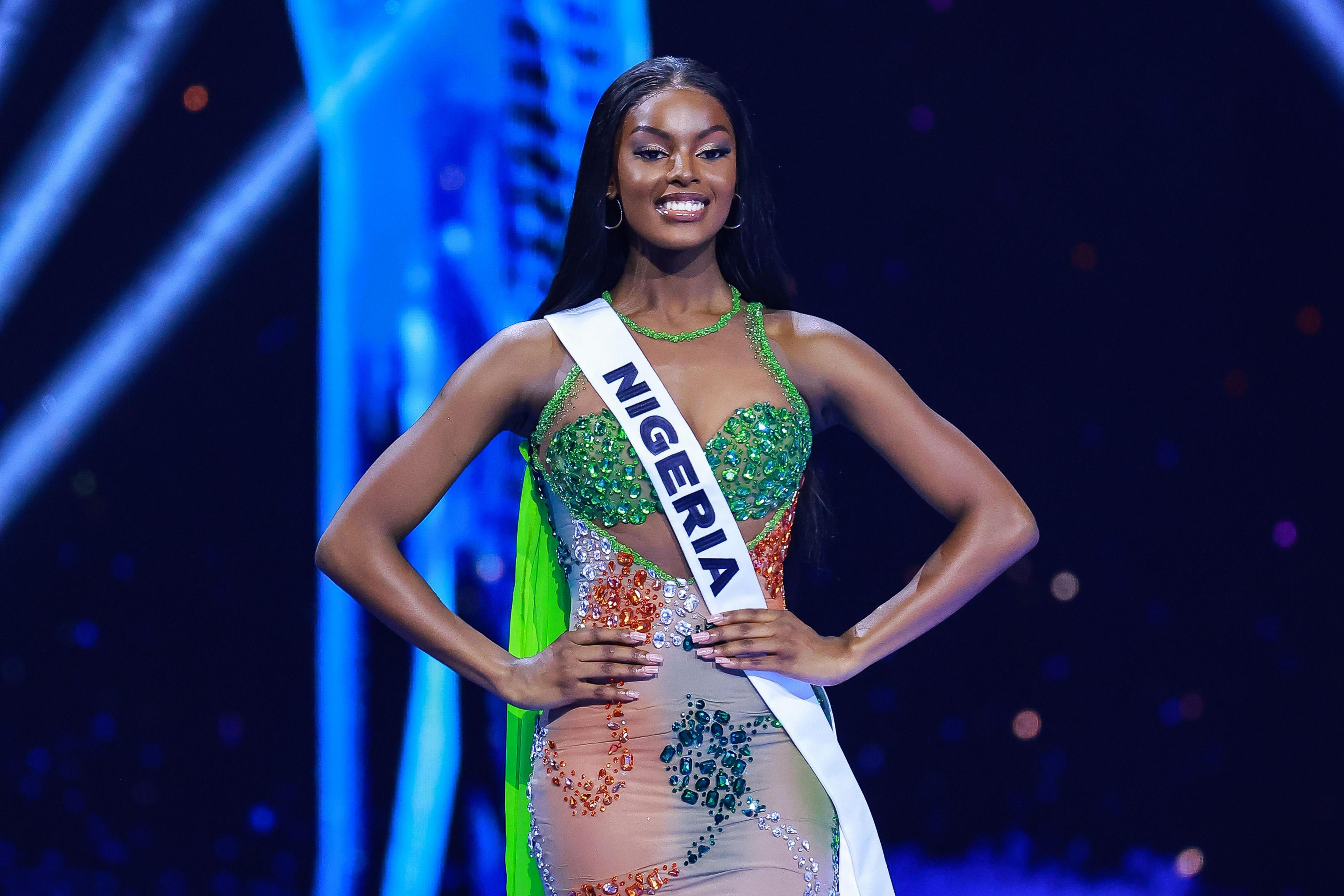 Nigeria's Chidimna Adetshina wear a green dress and poses with her hands on her hips. A simple white sash that says Nigeria is draped across her body from shoulder to hip - Saturday 16 November 2024