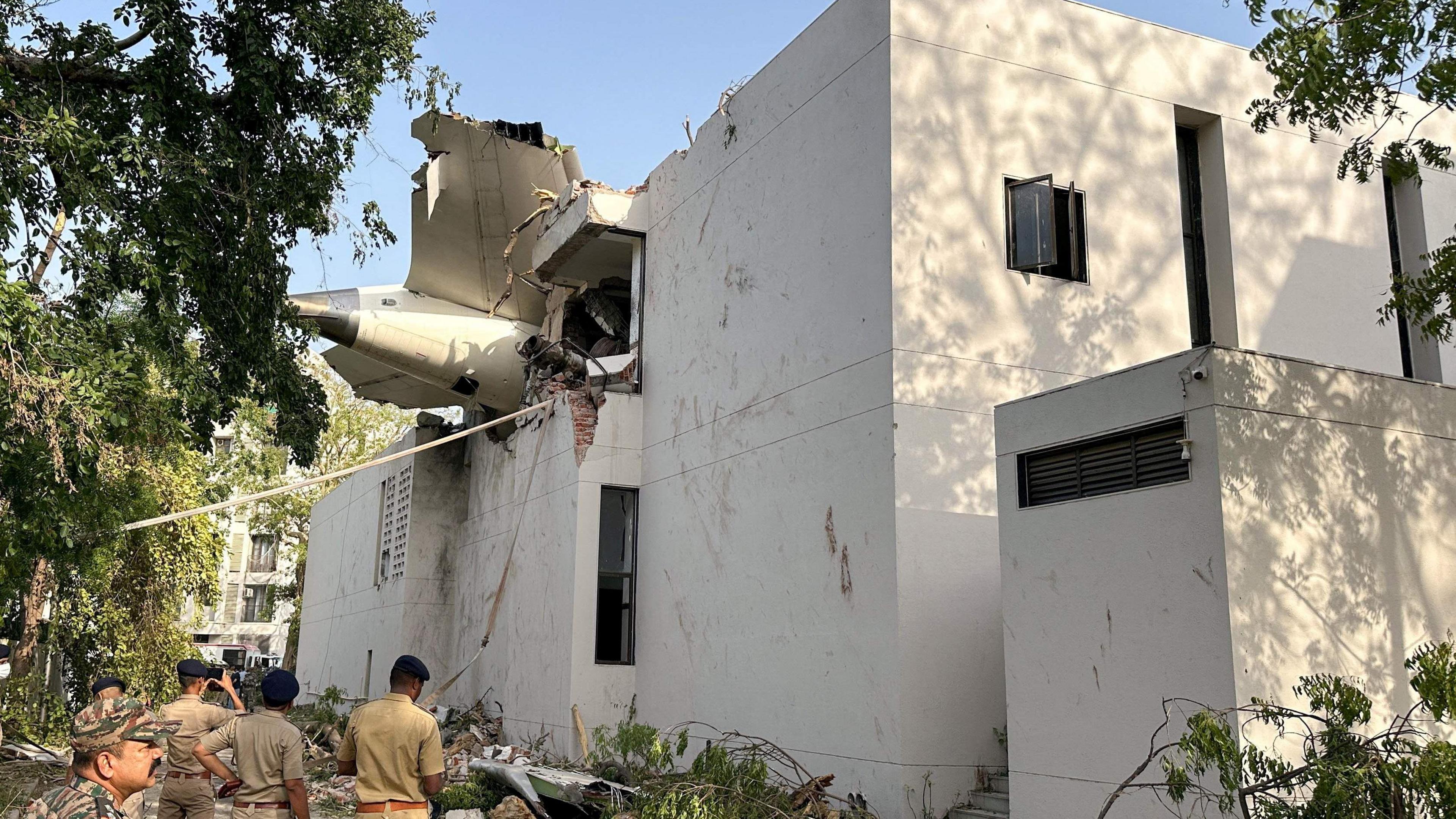 A tail of an Air India Boeing 787 Dreamliner plane that crashed is seen stuck on a building after the incident in Ahmedabad, India, June 12, 2025. REUTERS/Amit Dave