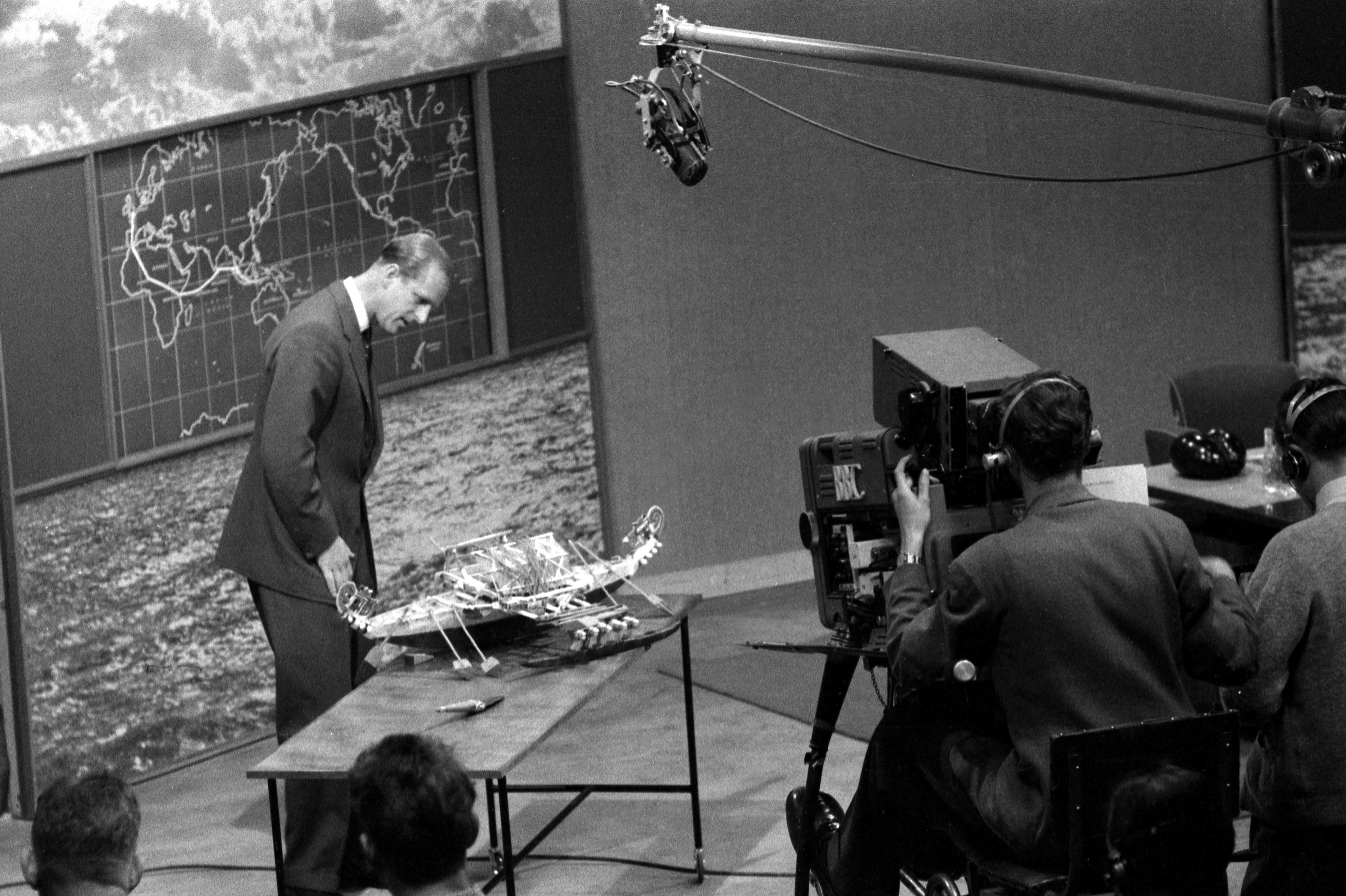 The Duke of Edinburgh with a miniature canoe from Manus, New Guinea, in 1957