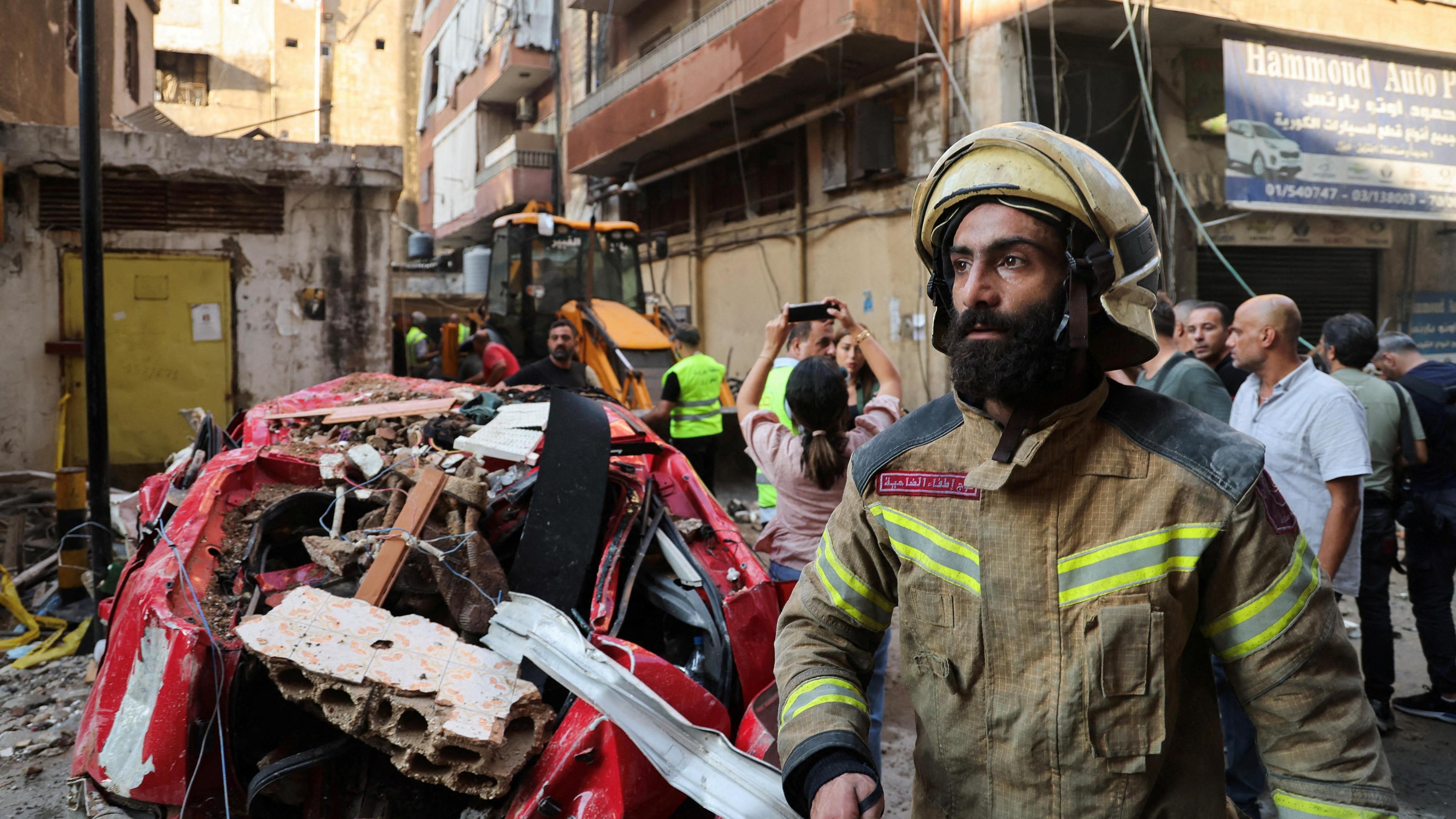 A firefighter works at the site of an Israeli strike that the Israeli military says killed a senior Hezbollah commander, in Beirut's southern suburbs, Lebanon (24 September 2024)