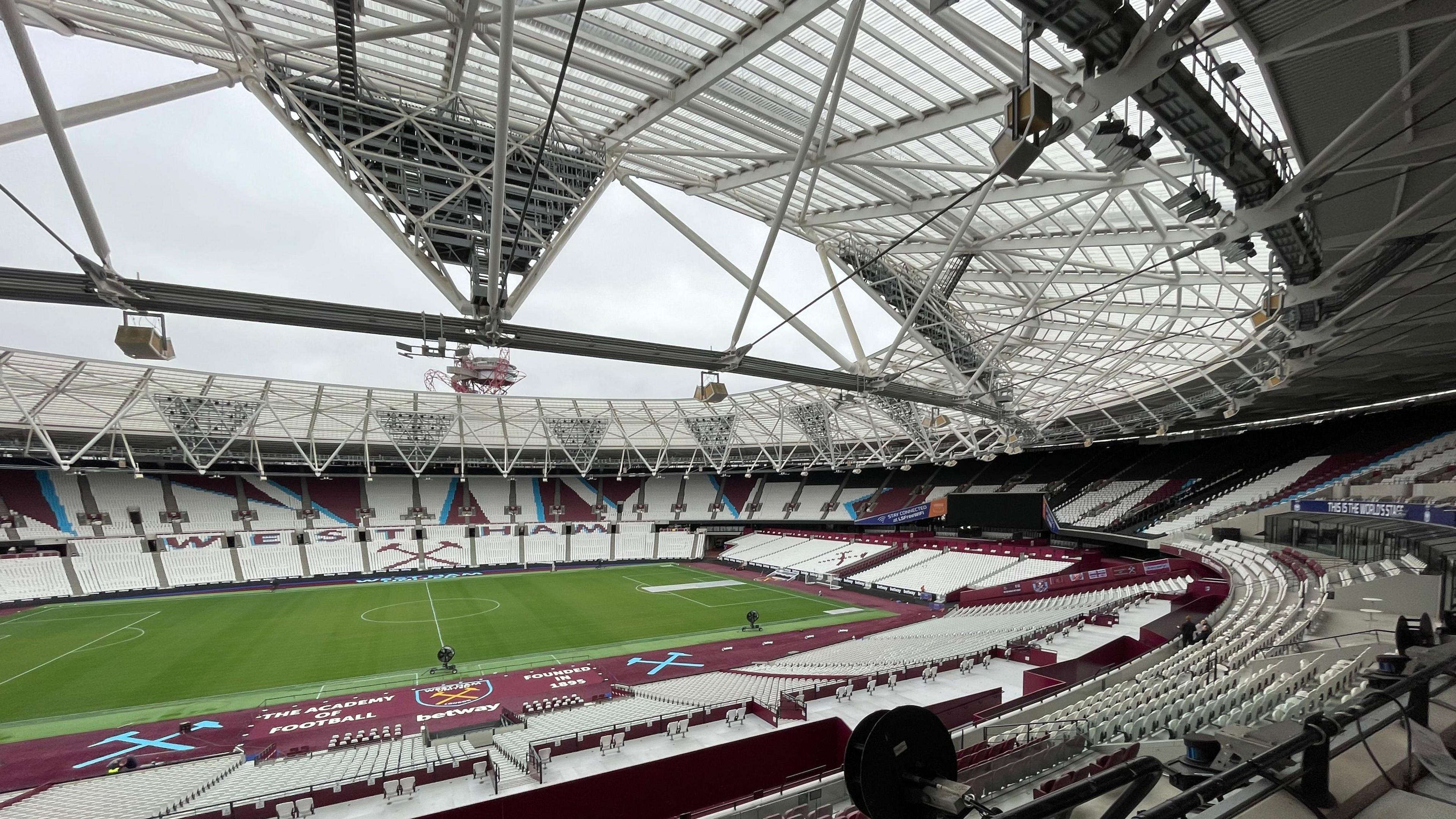 View from inside the London Stadium showing the stands and the roof.