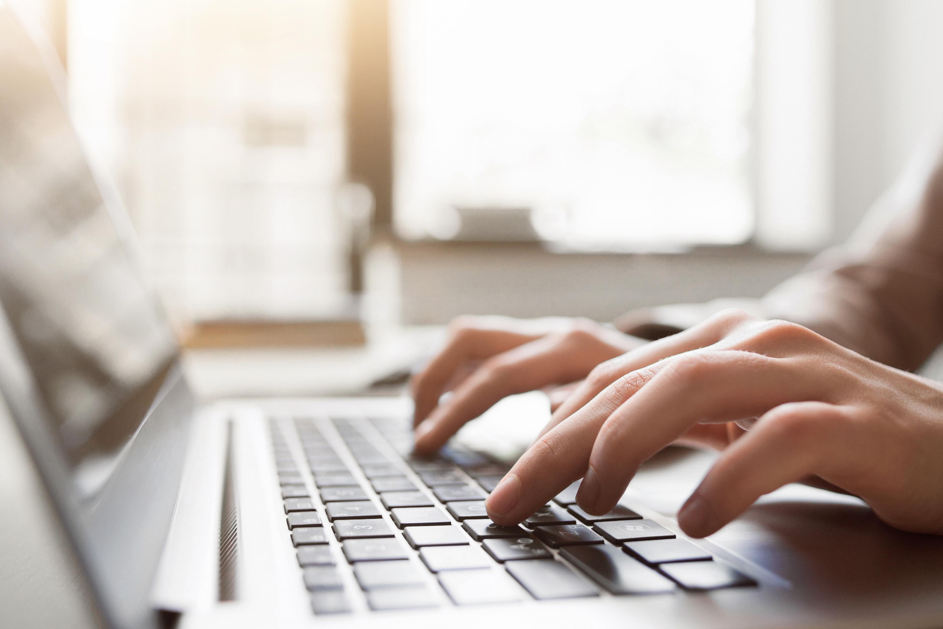 Person typing on a keyboard