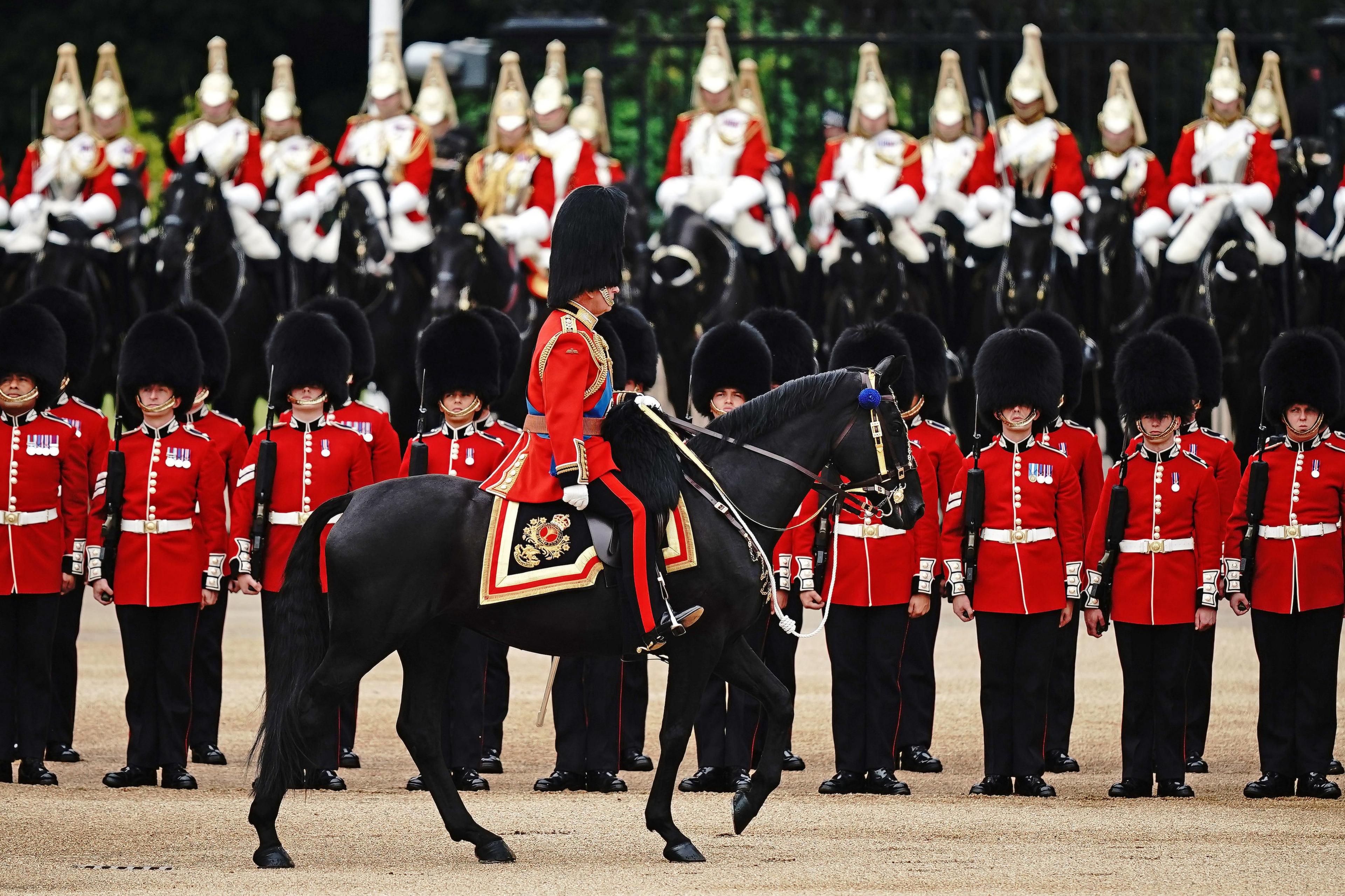 king charles inspecting soldiers during the trooping of the colour