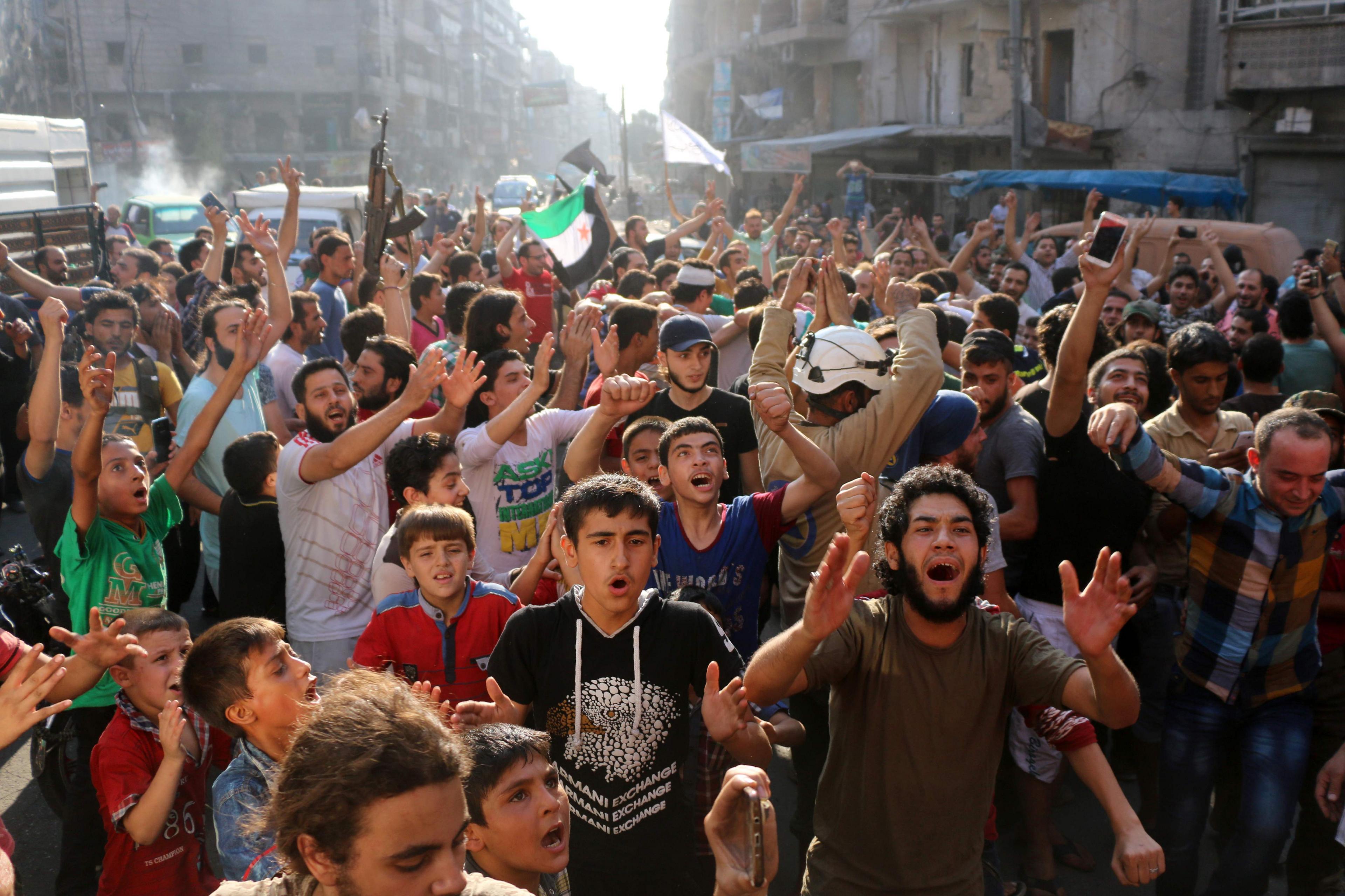 Syrians gather in a street in the northern city of Aleppo in celebrations after rebels said they have broken a government siege