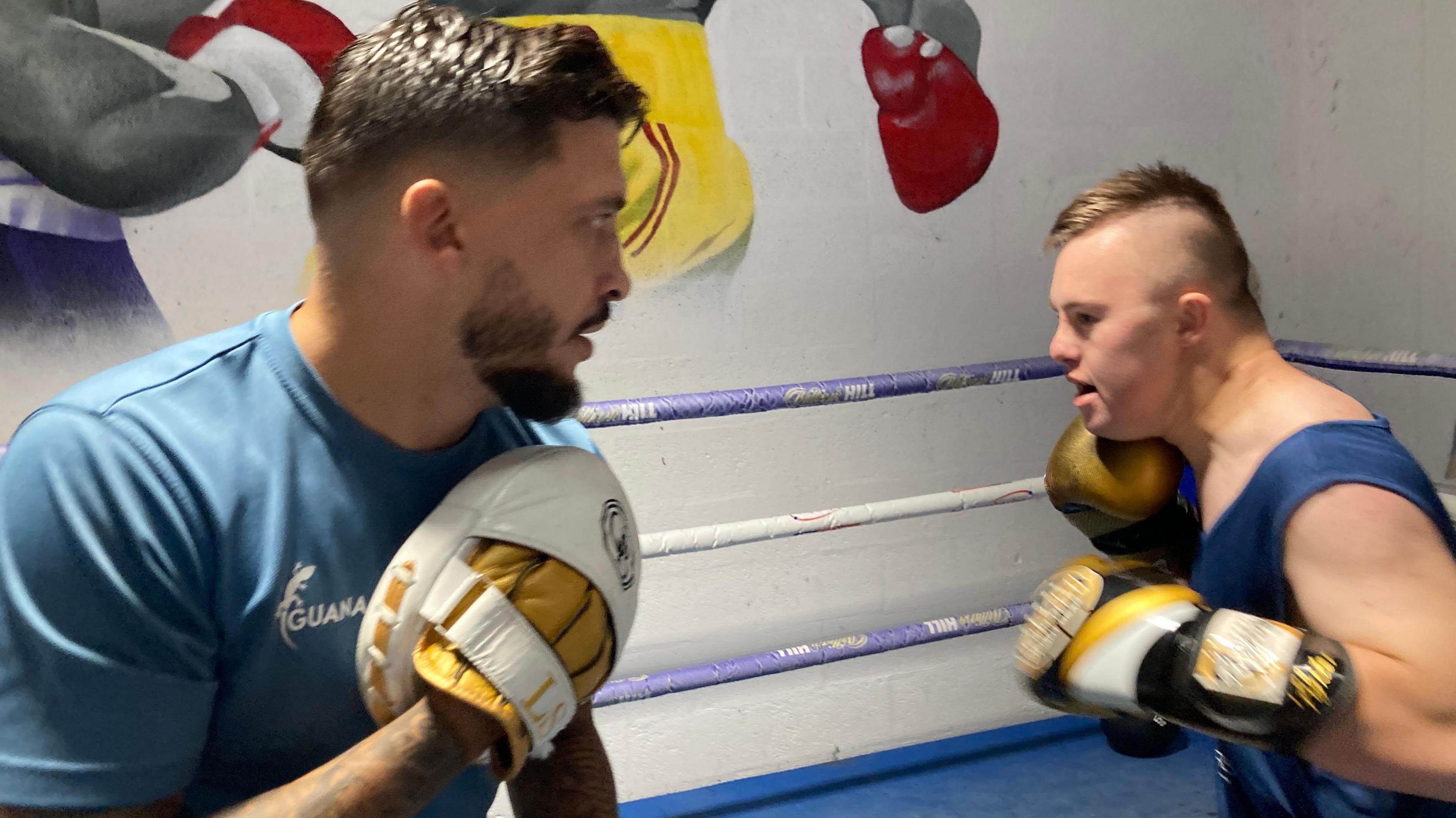 Lee Selby and Jake Edwards facing each other in the ring, both in a fighting pose