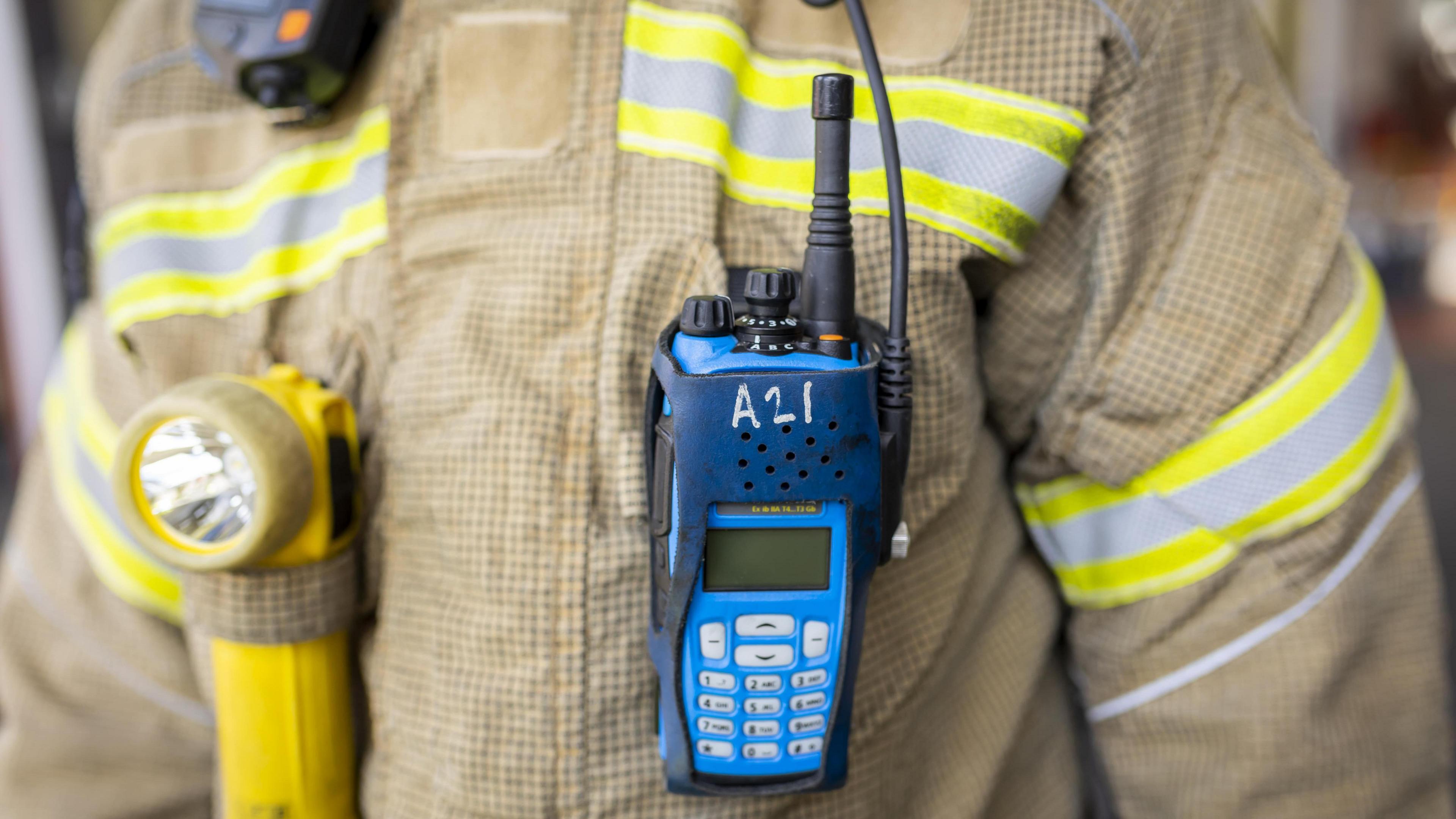 A firefighter wearing a fireground radio