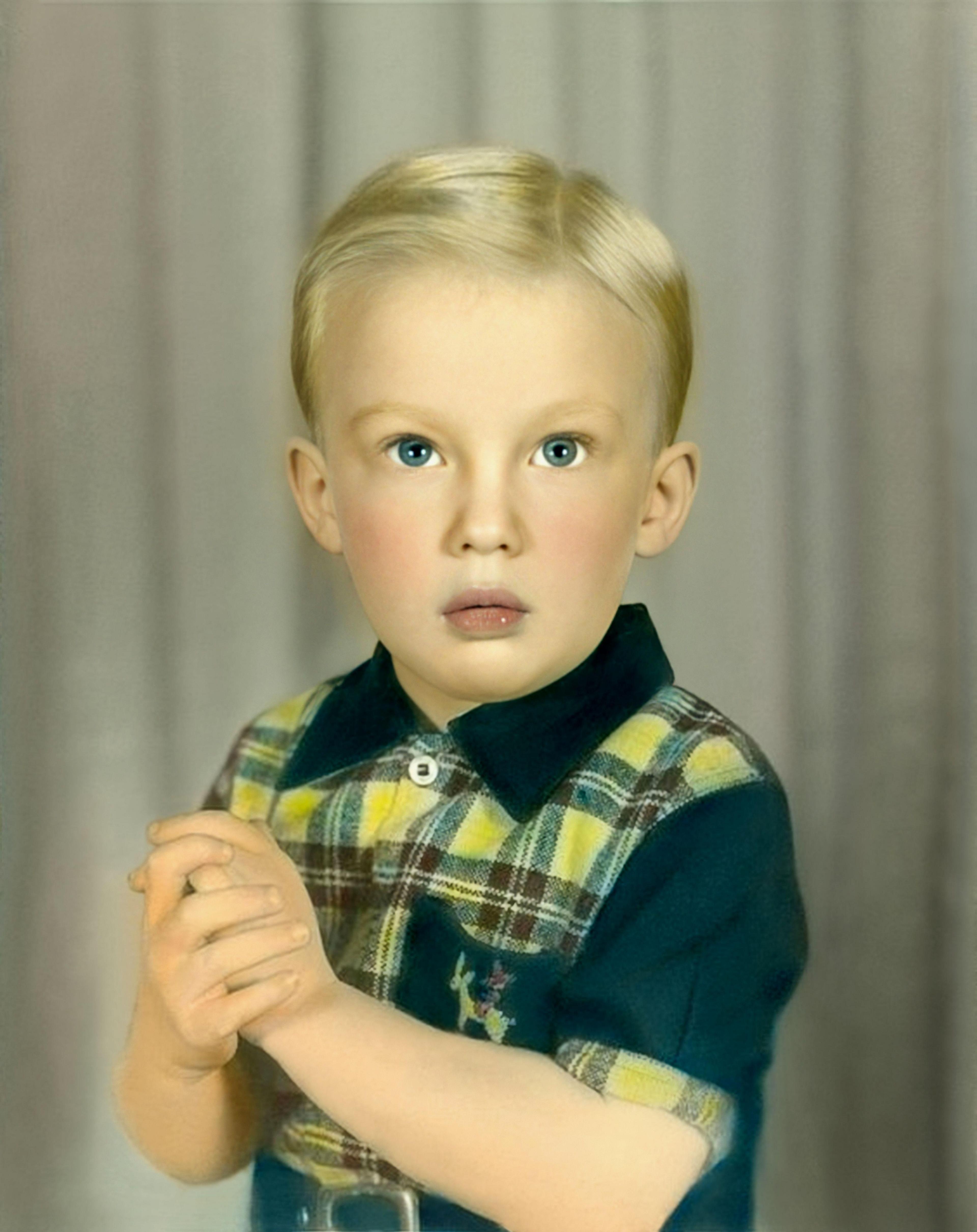 Donald Trump aged 3 holding his hands together