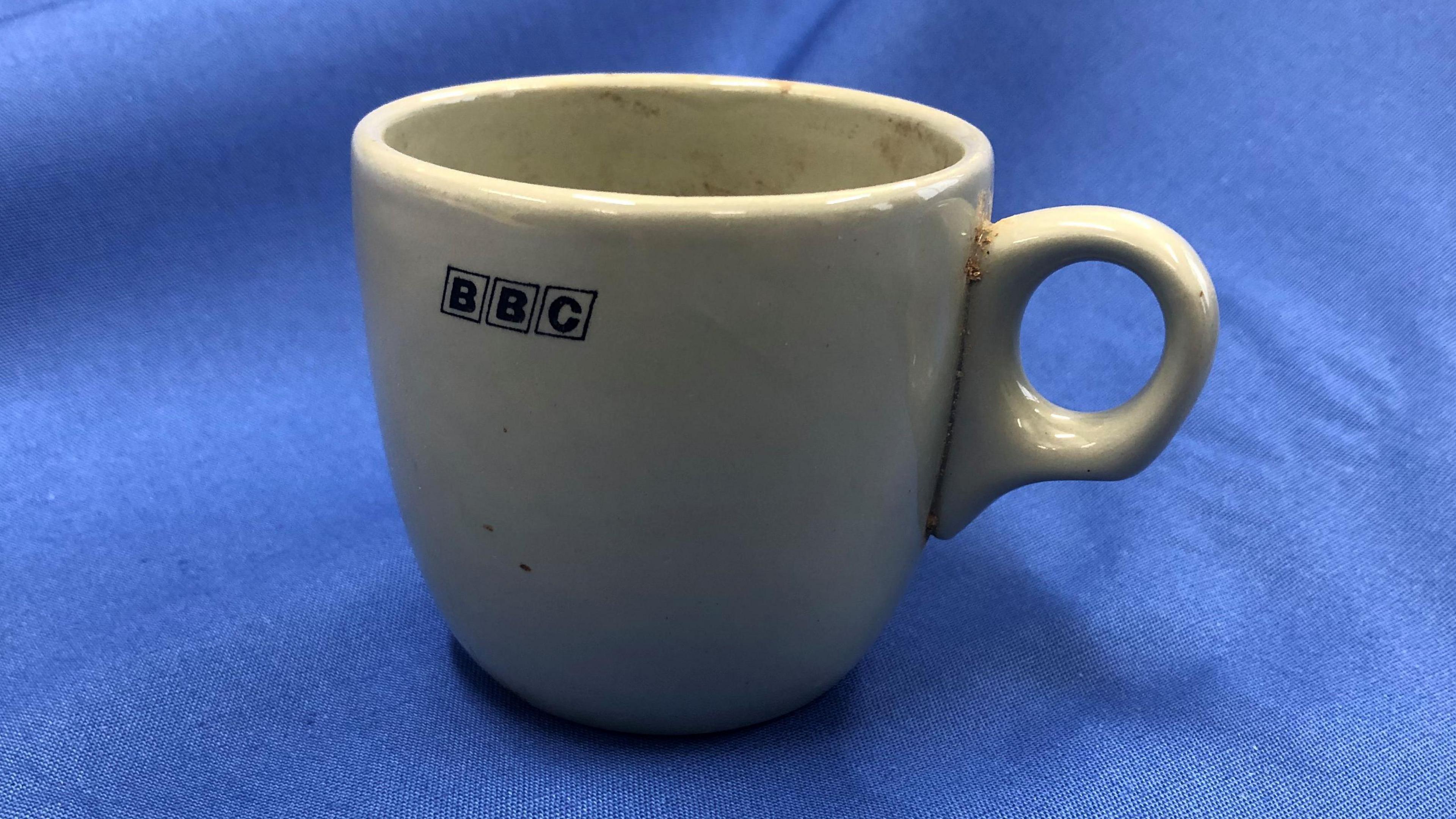 A BBC coffee cup with 1960s logo.