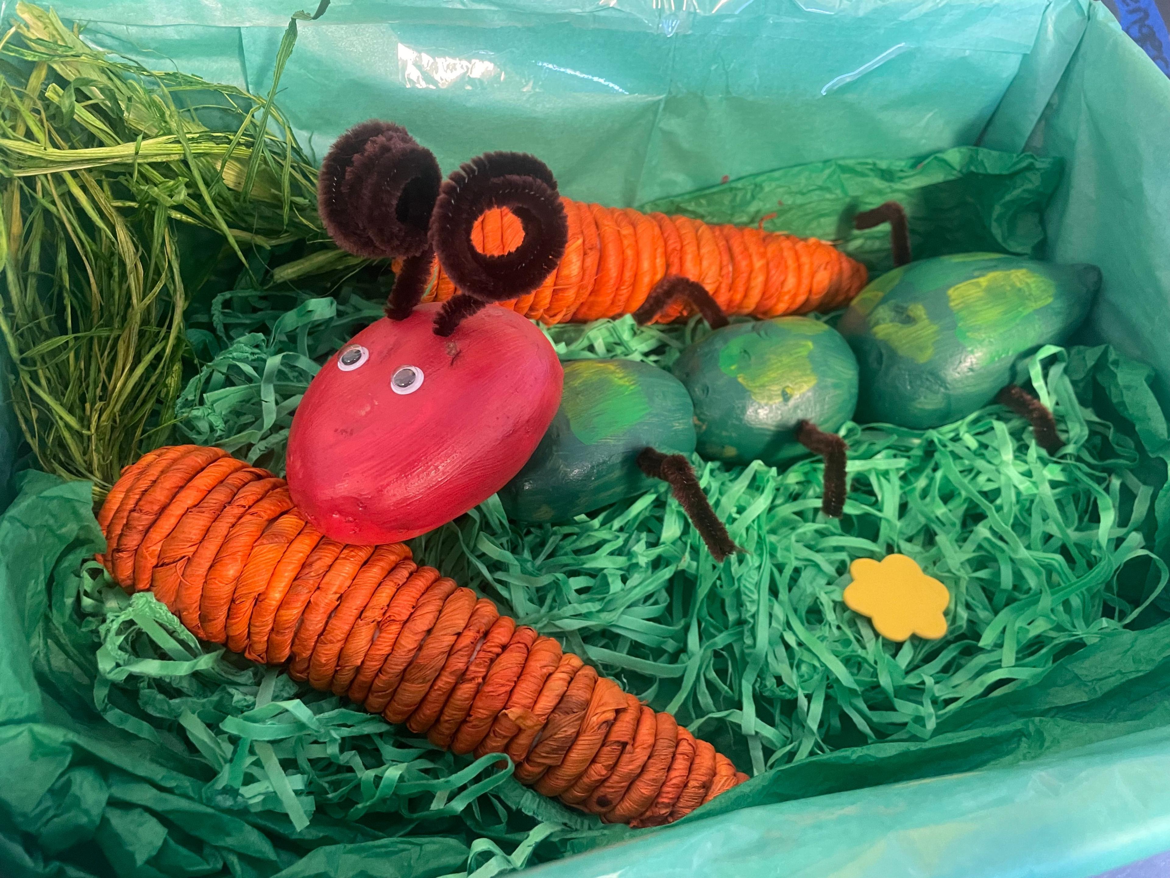 four potatoes painted to look like the children's book character A Very Hungry Caterpillar