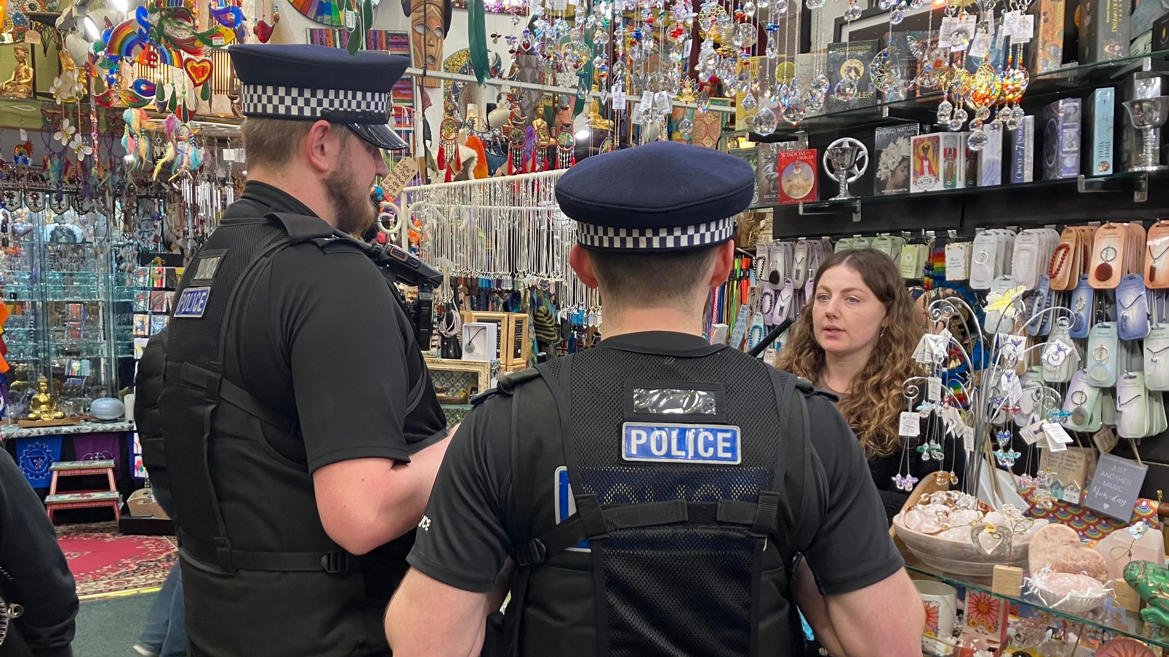 Kent Police officers speaking to a shop manager in Maidstone