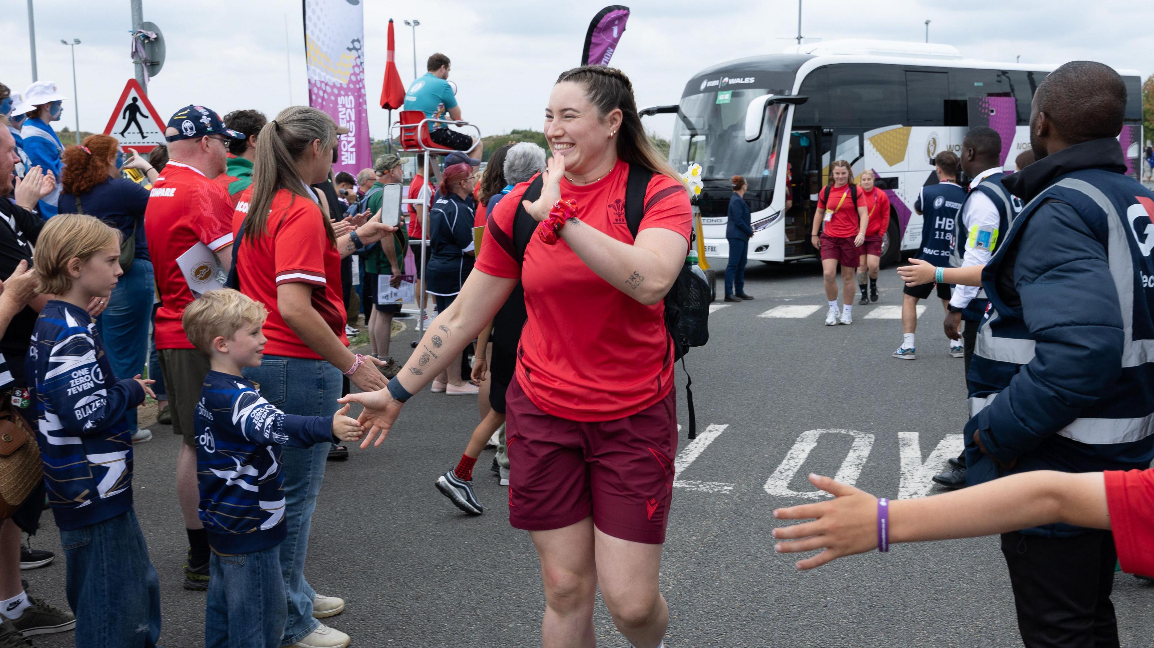 Gwen Crabb greets fans as she arrives at the stadium