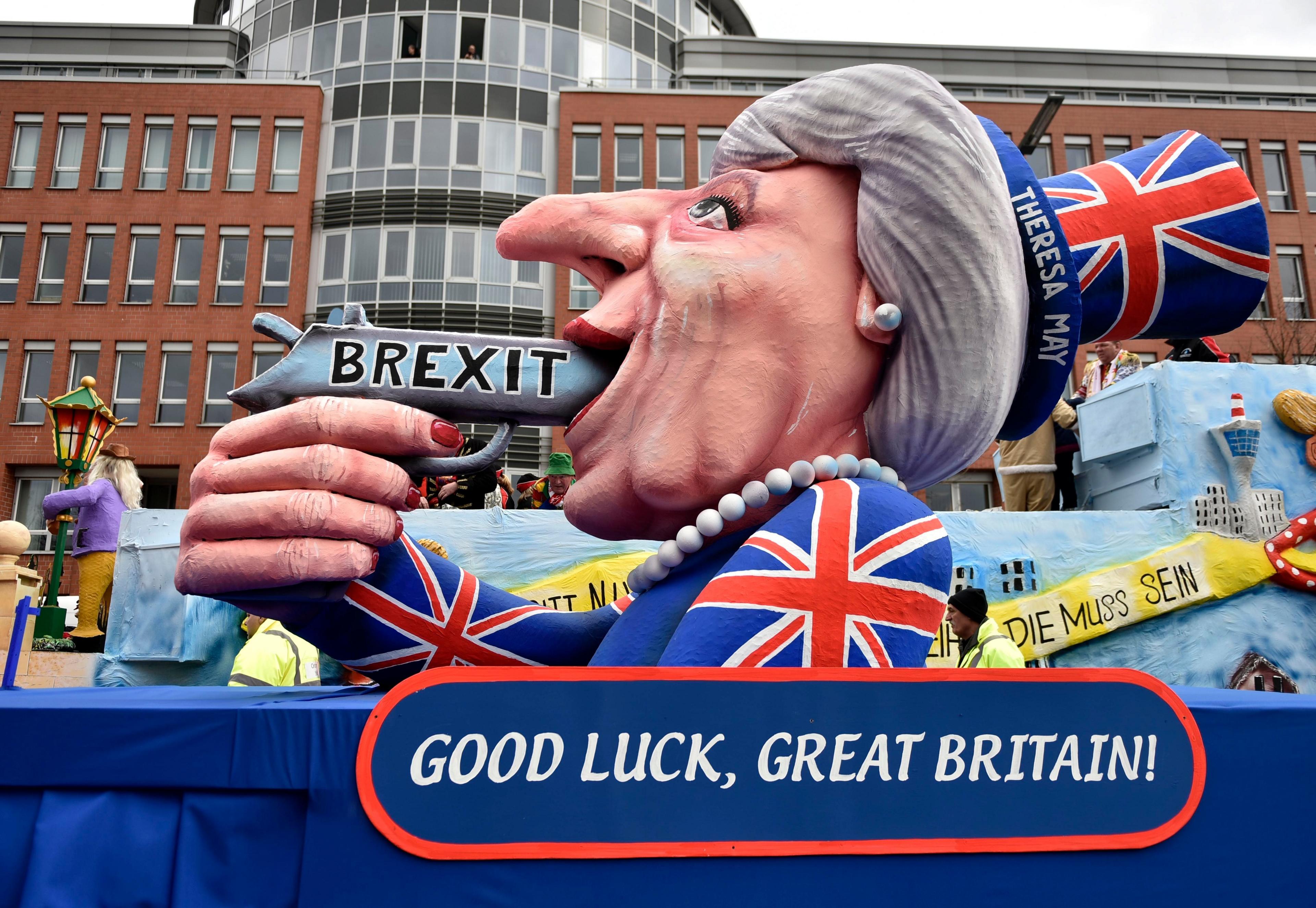 A carnival float depicts British Prime Minister Theresa May with a gun and the writing "Brexit" on it prior to the traditional carnival parade in Duesseldorf, Germany, on Monday, Feb. 27, 2017.