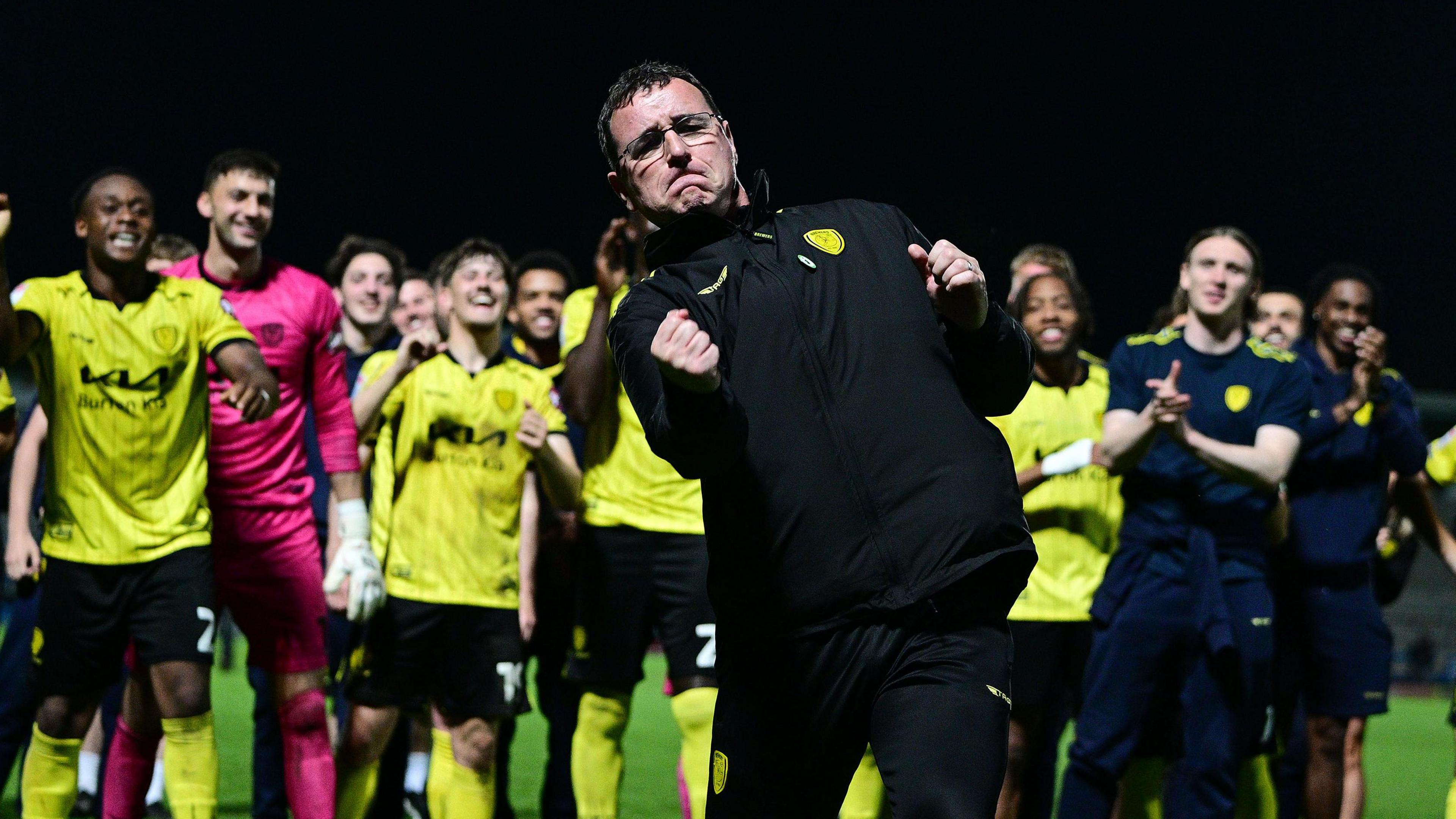 Burton boss Gary Bowyer punches the air as he celebrates the club's League One survival