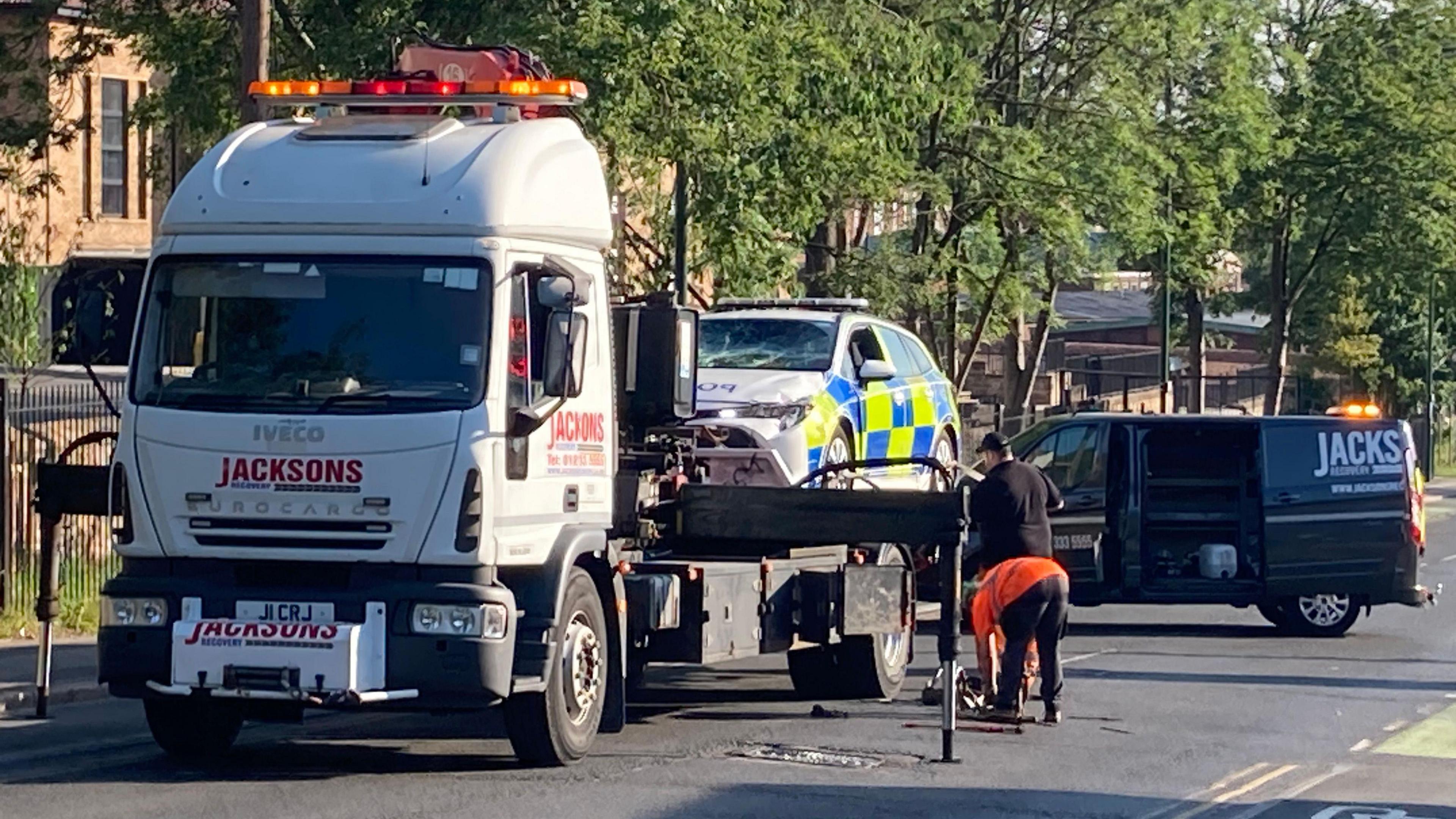 A recovery truck with a police car on the back of it in Carlton Road, Nottingham

