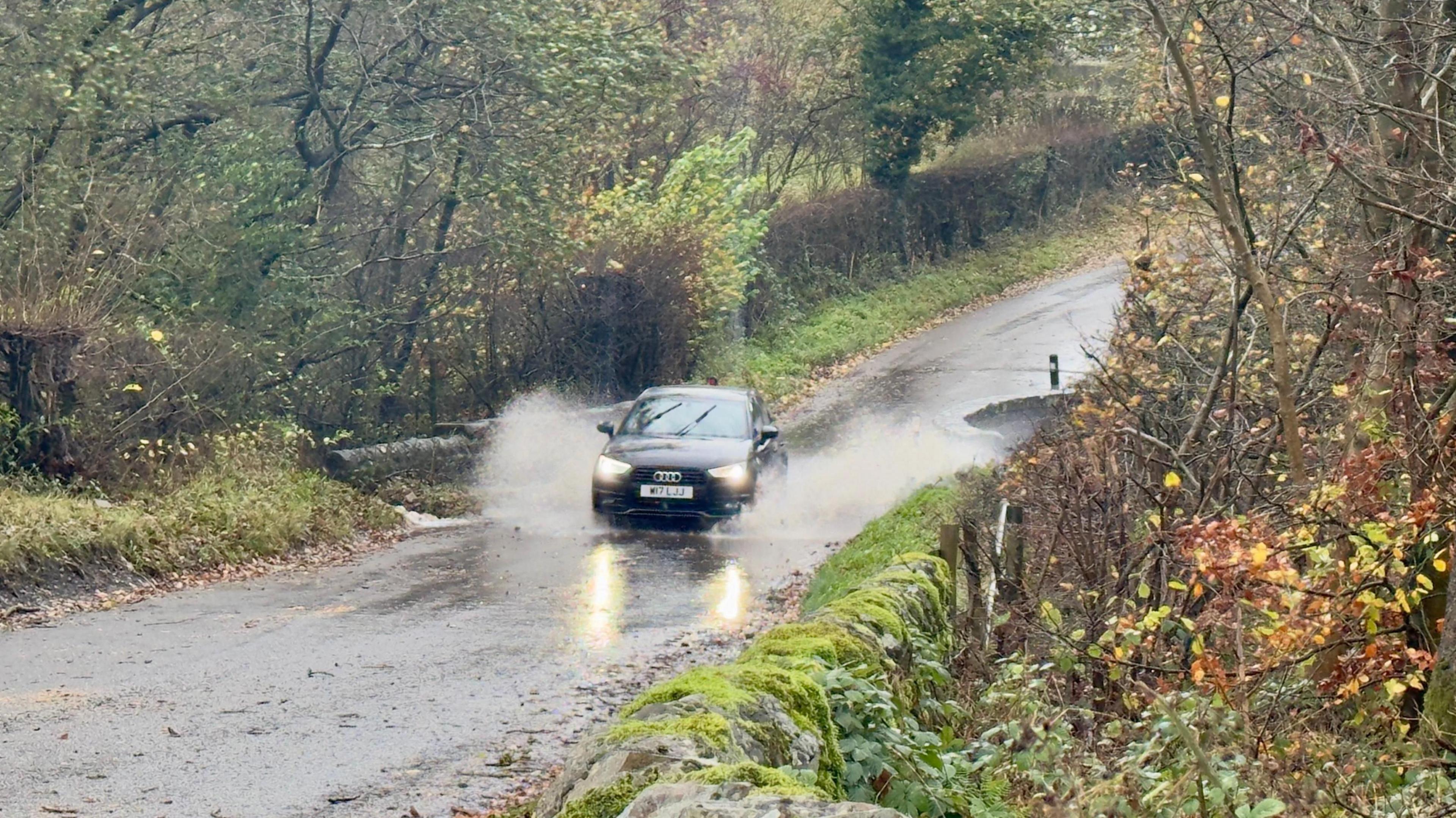car driving through a flood road