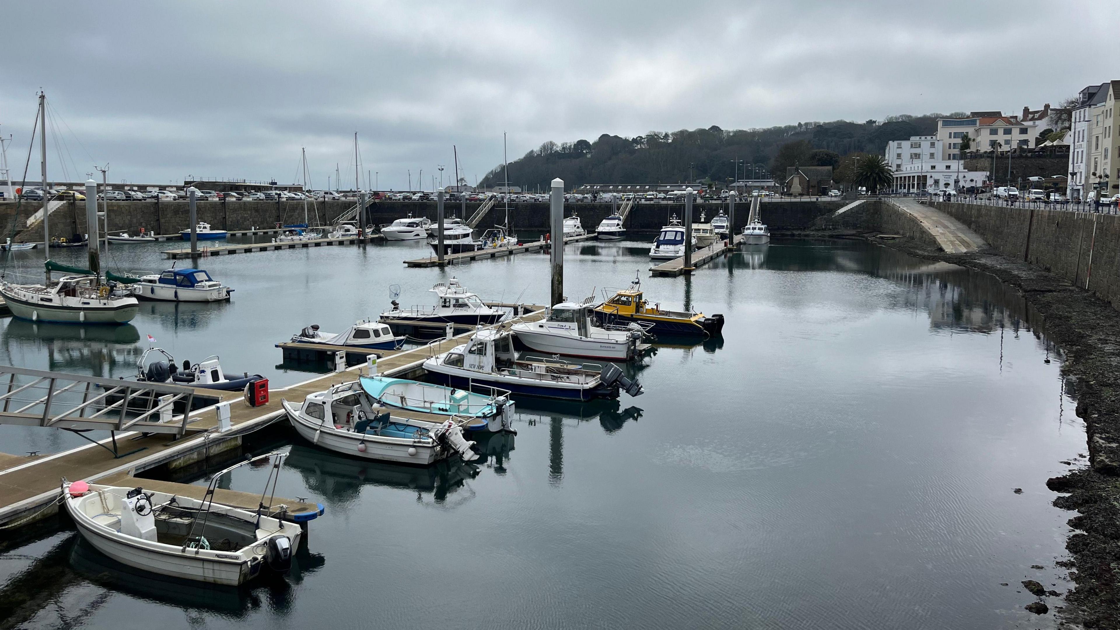 St Peter Port harbour in Guernsey. Boats are moored on pontoons.