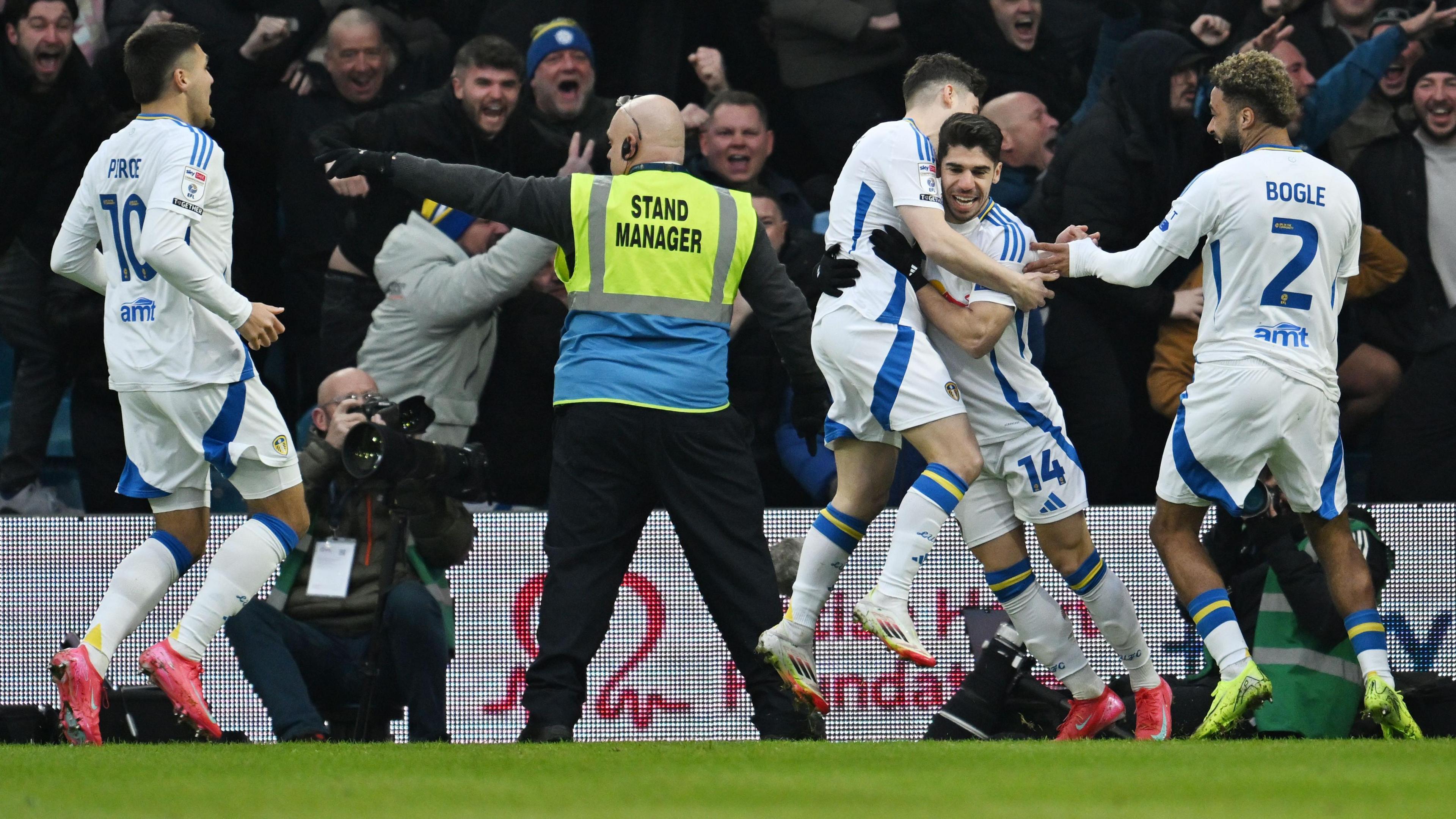 Leeds United players celebrate scoring a goal against Sheffield Wednesday