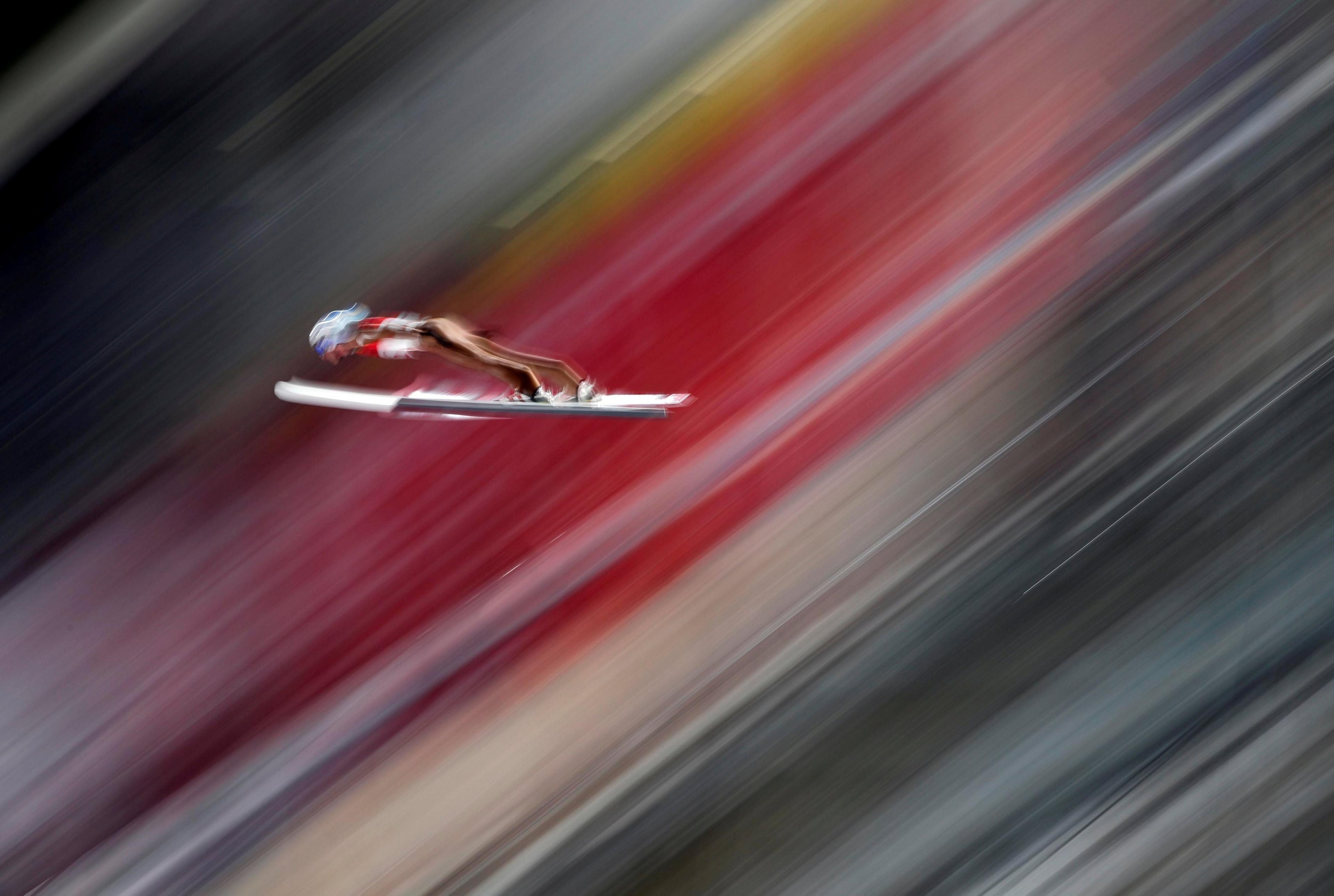 Dawid Kubacki is seen on skis in mid-air