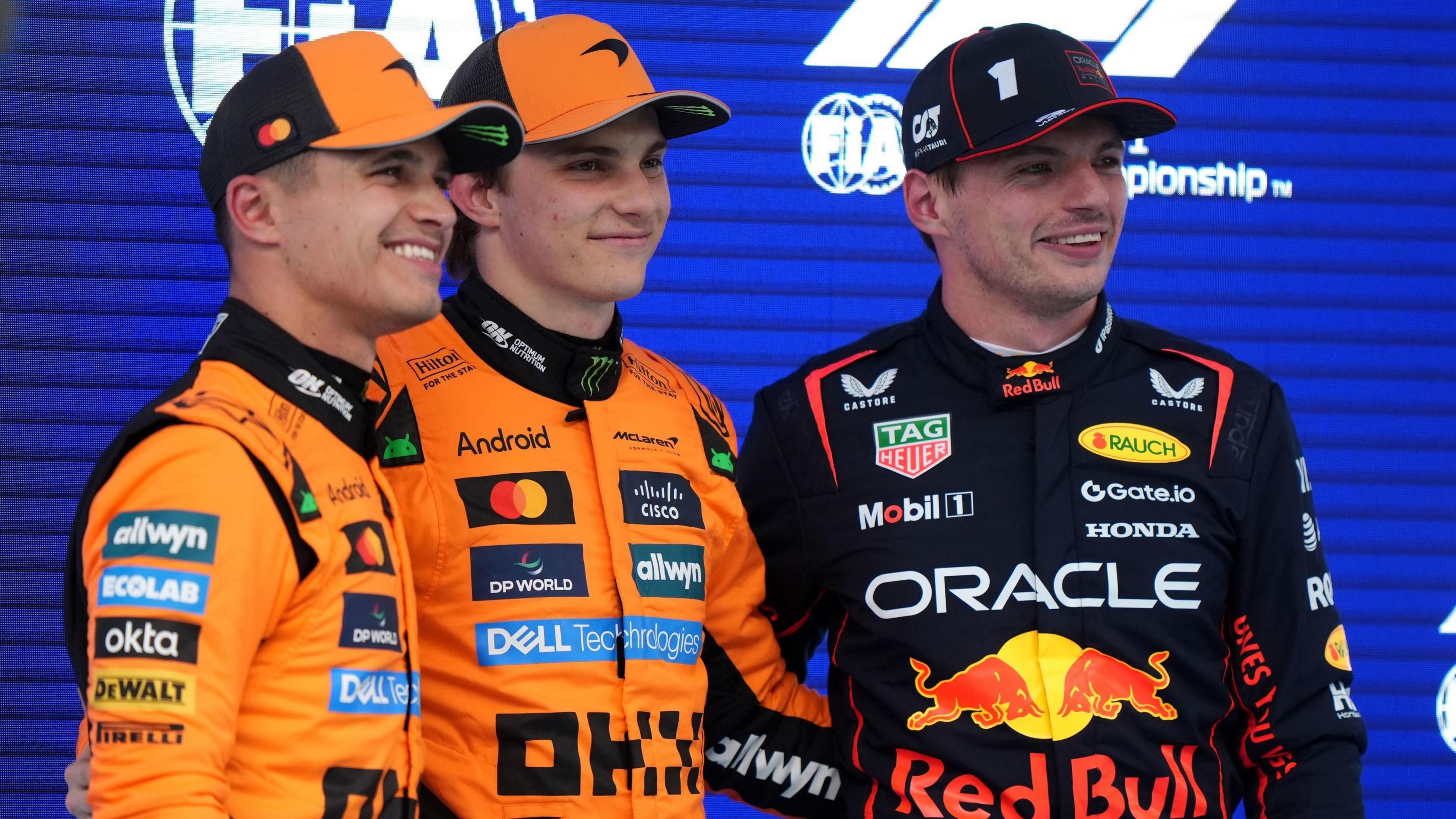 Lando Norris, Oscar Piastri and Max Verstappen pose for photos after qualifying as the top three in Spain