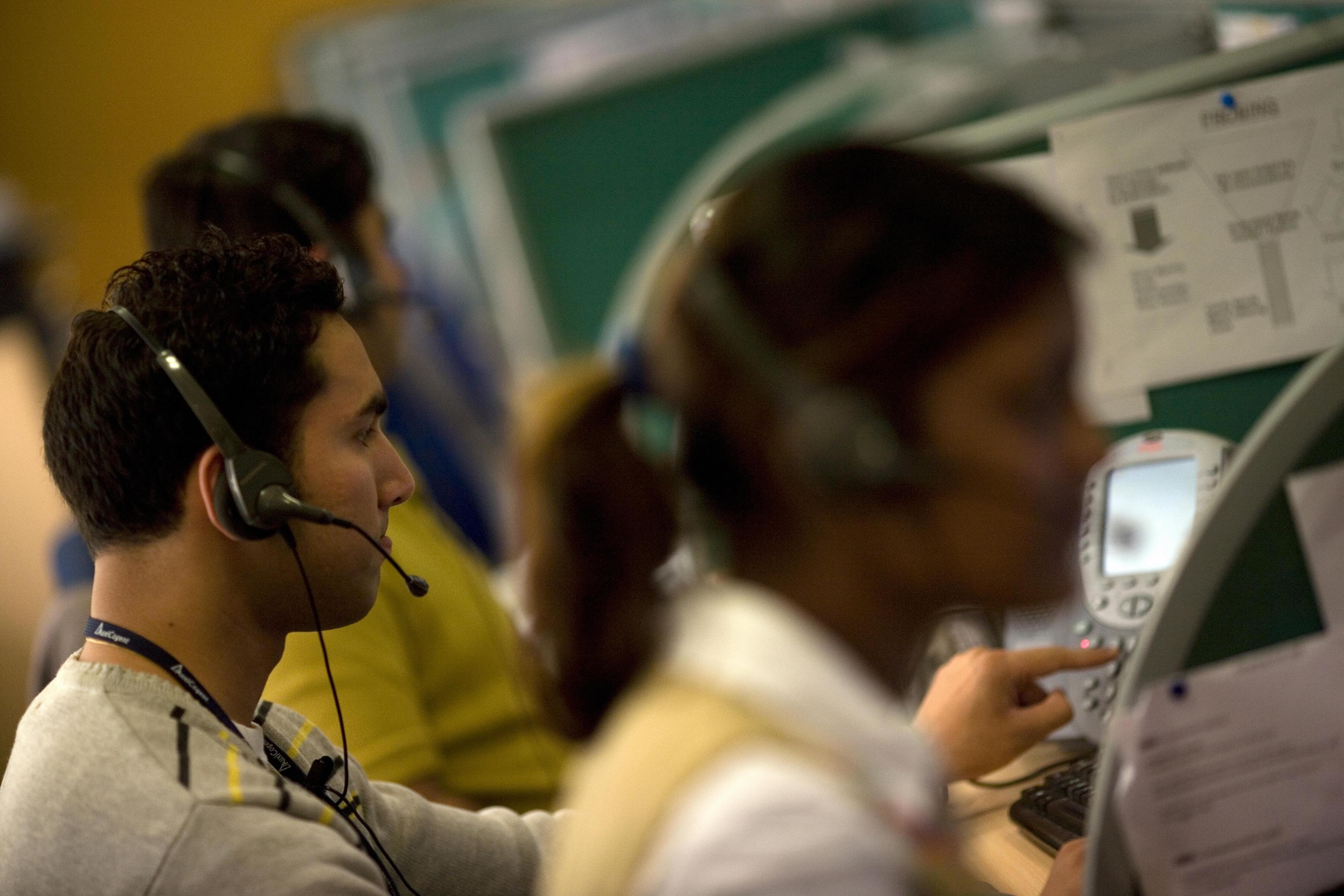 Indian workers answer telephone calls at a call-centre in New Delhi.