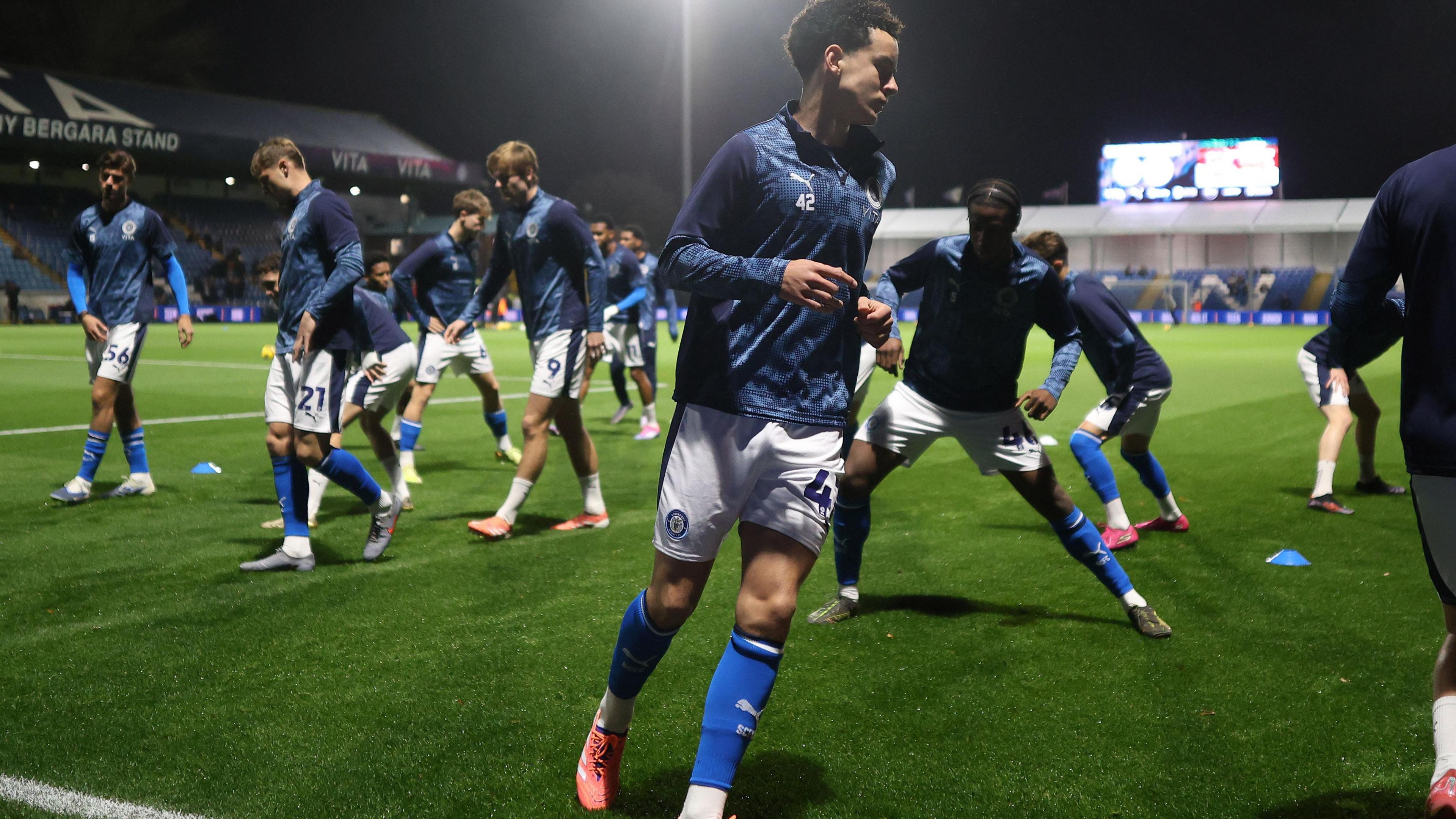 Arian Allen warms up for Stockport County last season before their EFL Trophy game against Wigan Athletic