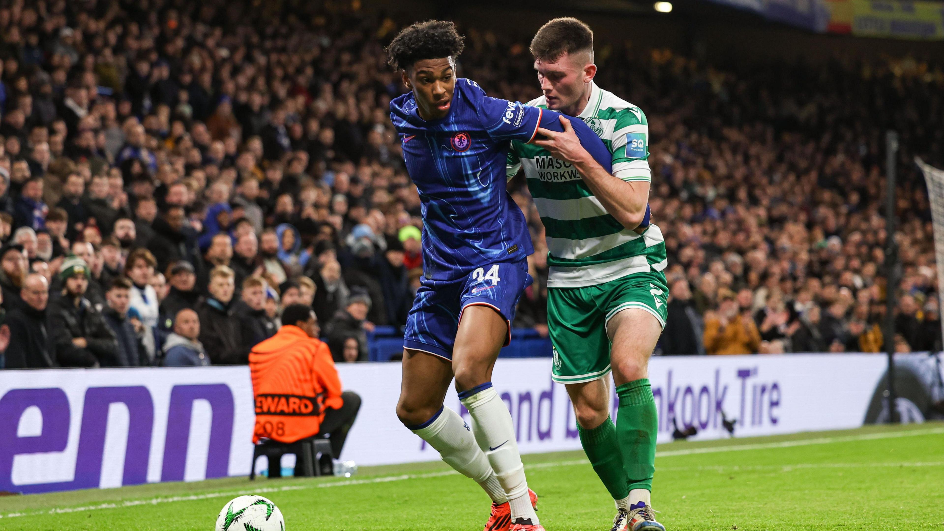 Josh Honohan takes on Joshua Acheampong of Chelsea
