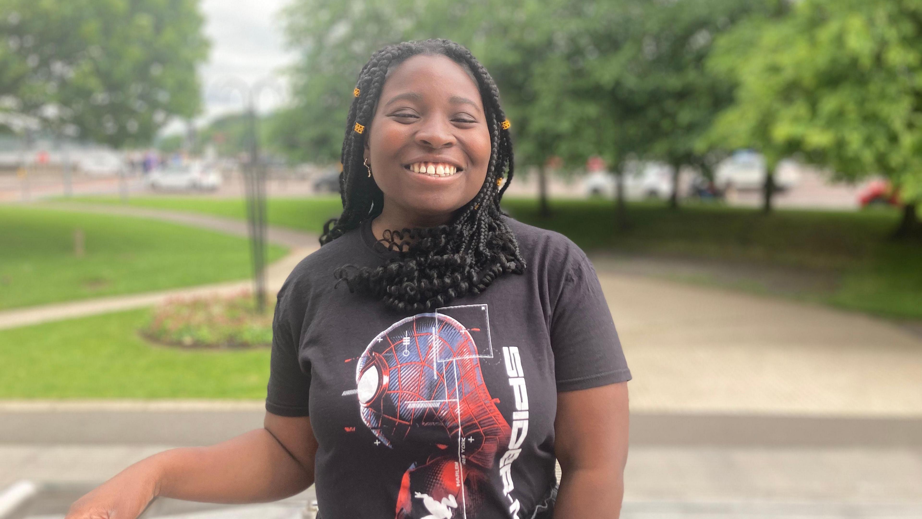 Jada is smiling into the camera. She is wearing a spiderman t-shirt