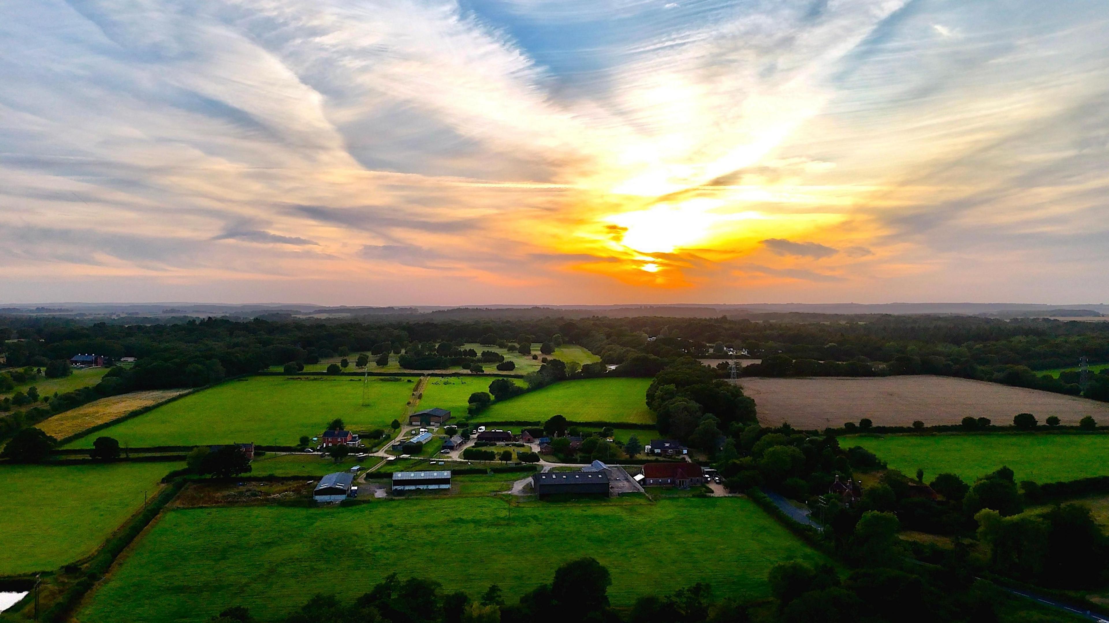 The sunset going down over Verwood, with many fields pictured around it