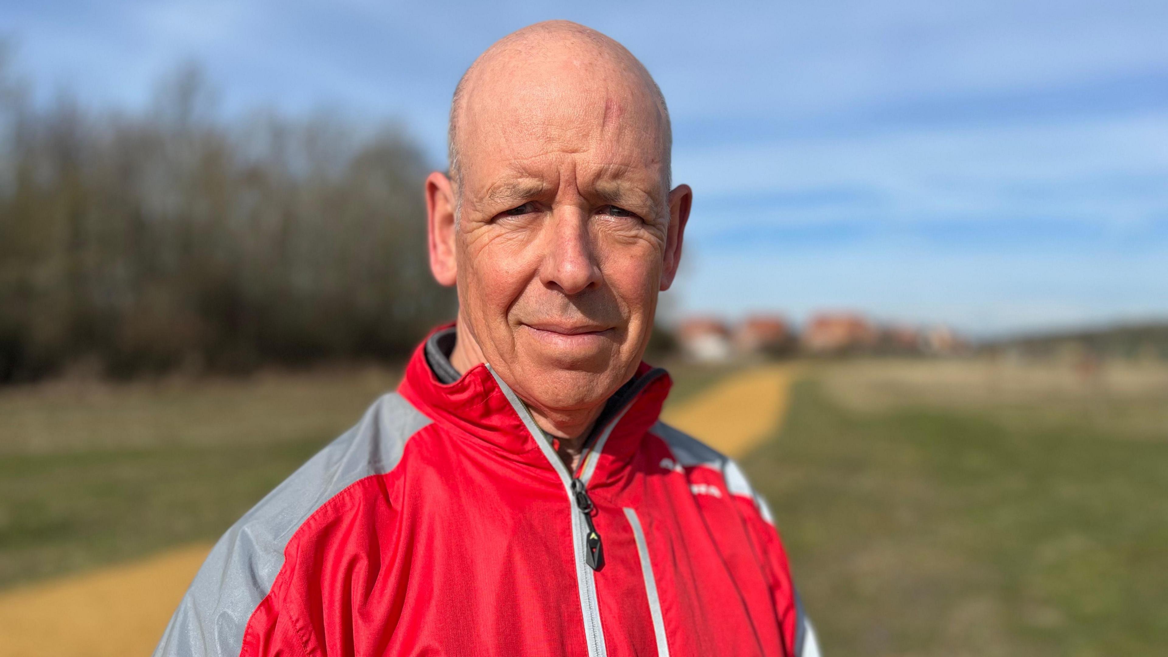 Jeff Peters from Bingham wearing a red cycling anorak