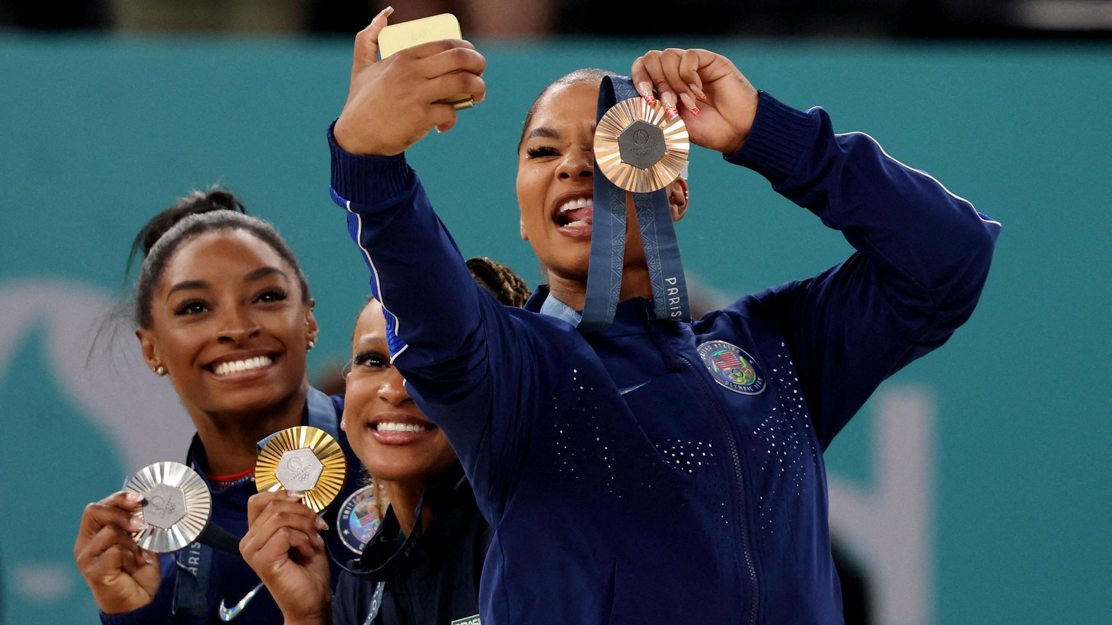 simone biles rebeca Andrade and jordan chiles with their medals.