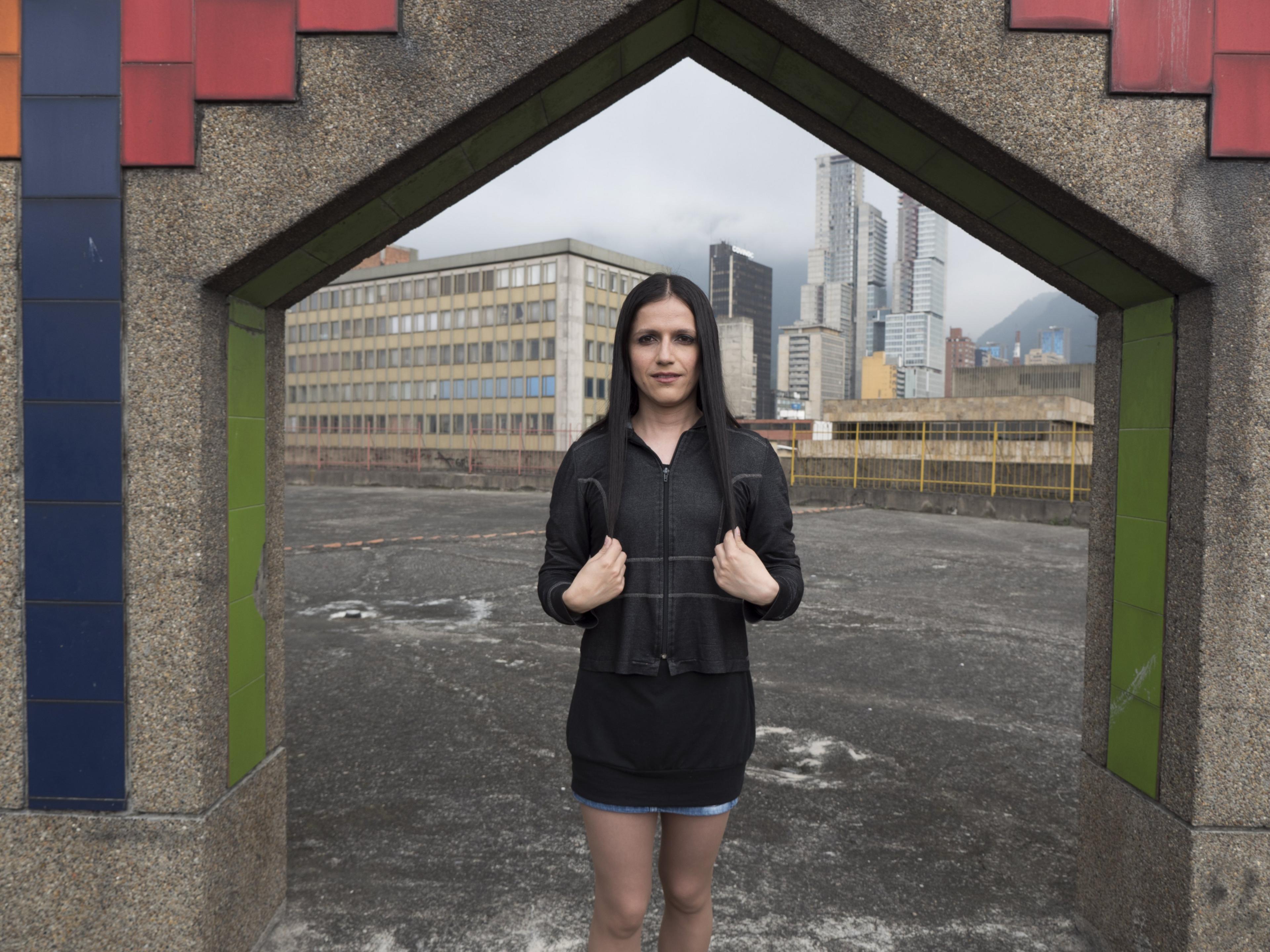 A woman who calls herself Andrea poses on the rooftop of Galax mall, where Tranxtienda is located