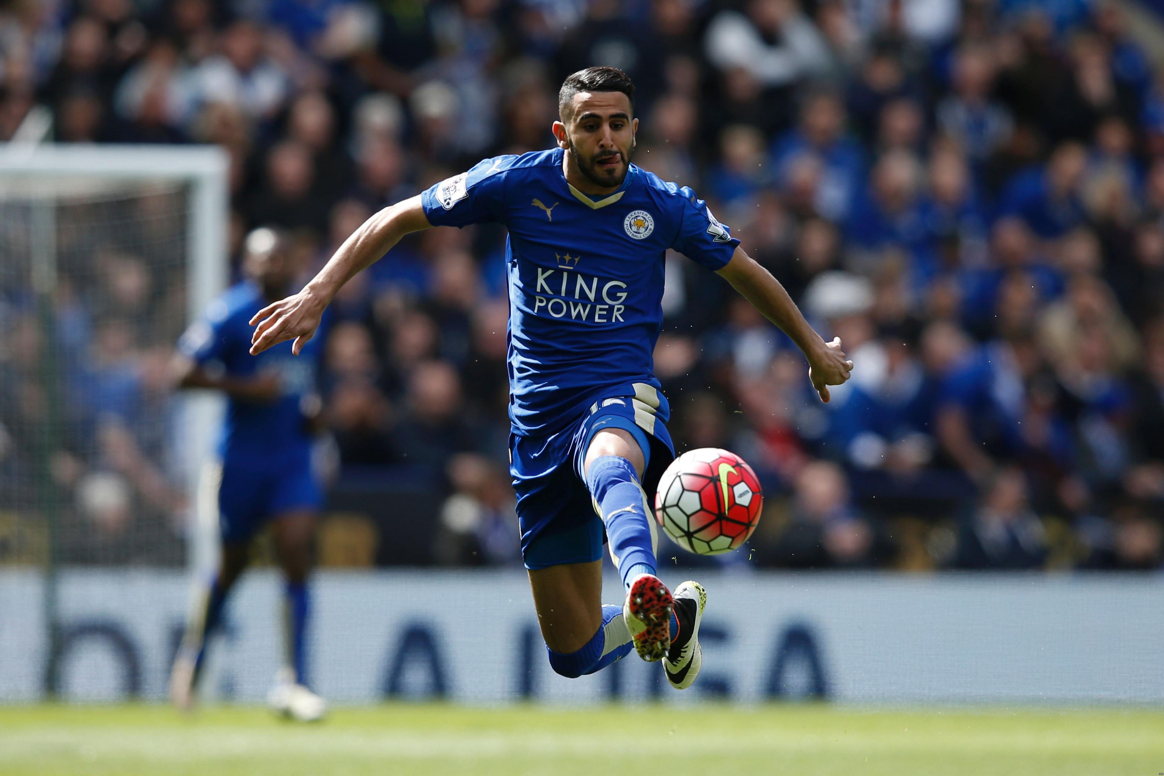 Riyad Mahrez kicking a football whilst playing a match with Leicester City