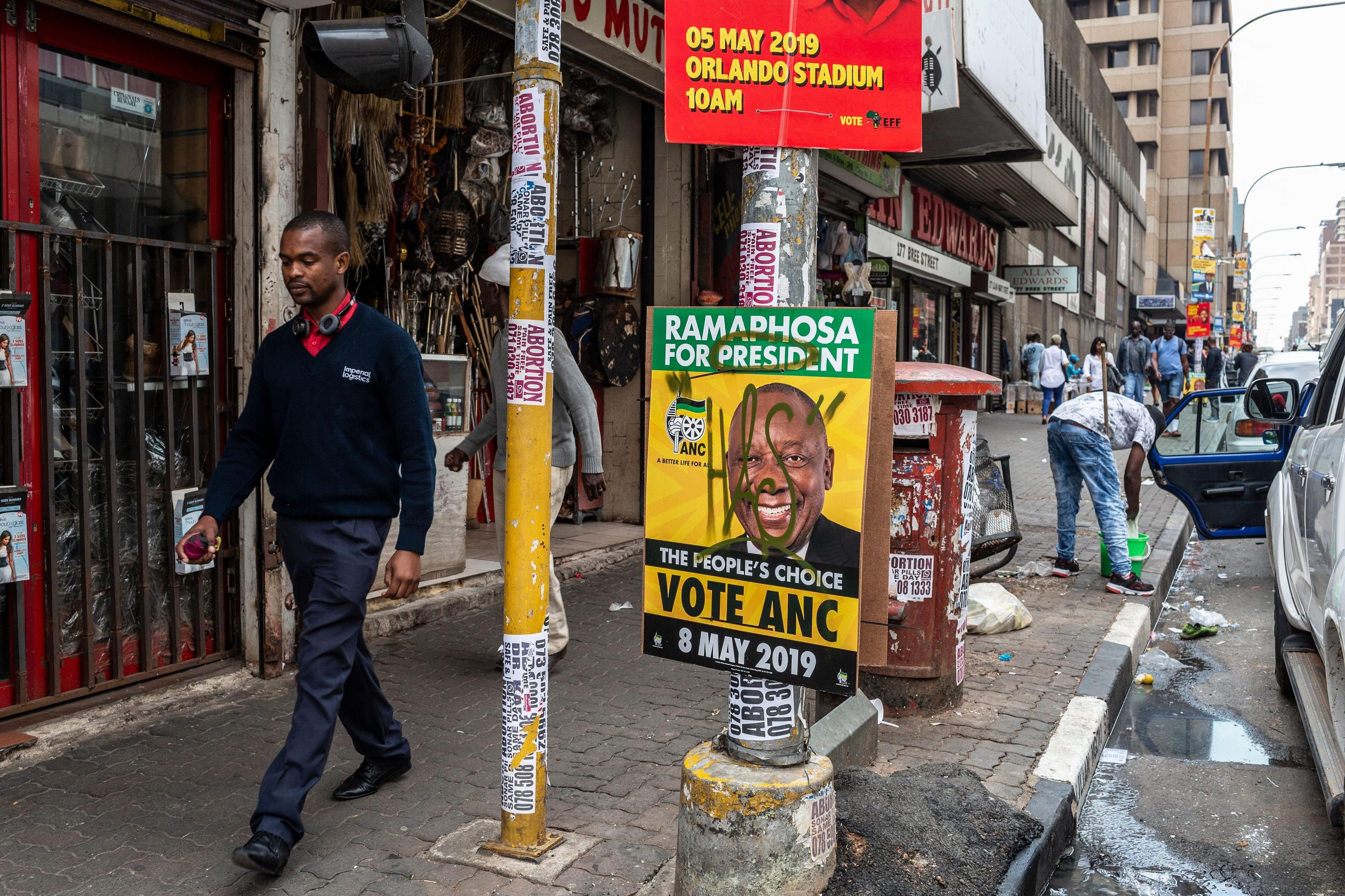 A man walks past an ANC election poster in Johannesburg