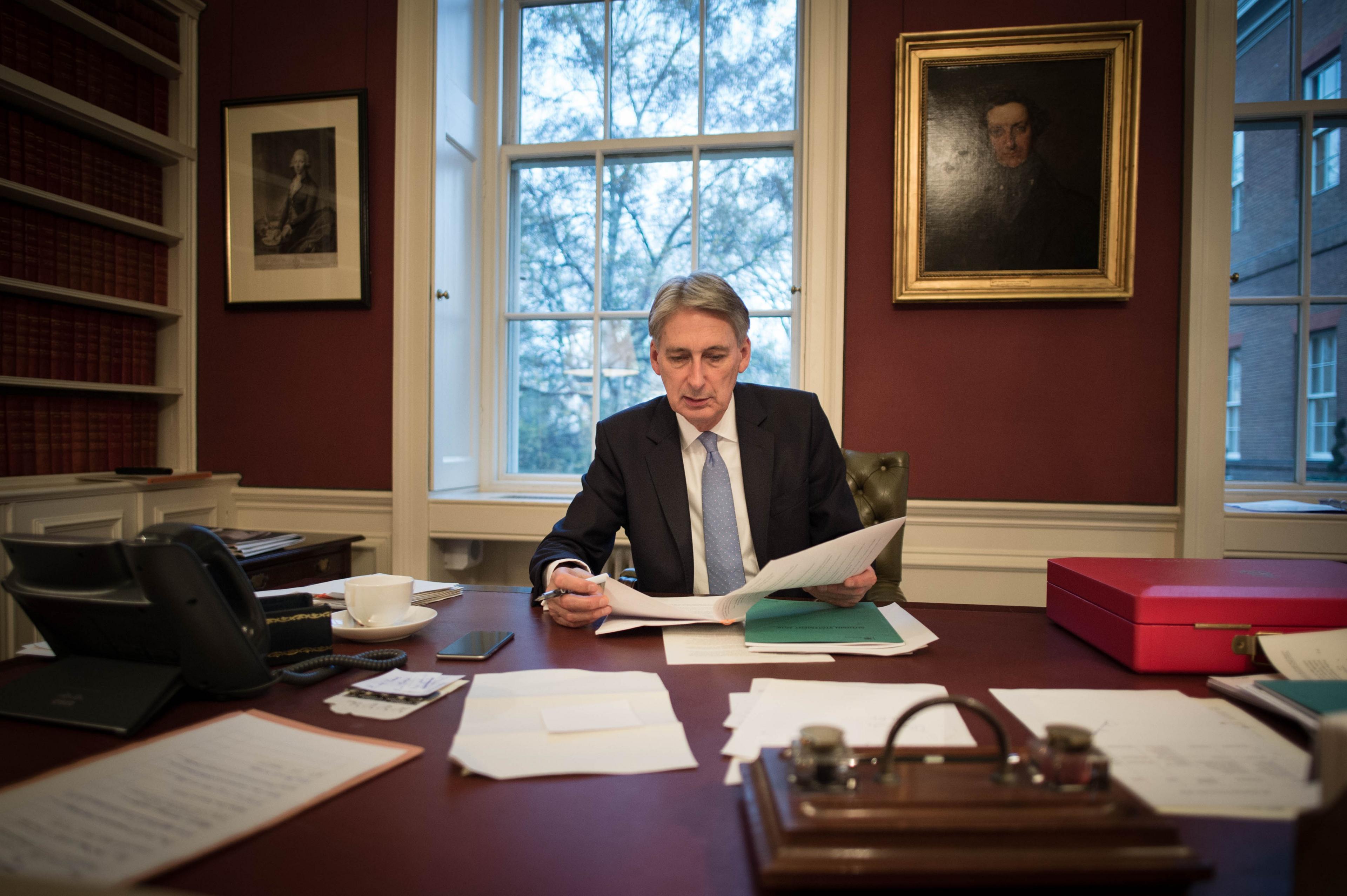 Chancellor of the Exchequer Philip Hammond reads through his Autumn Statement in his office in 11 Downing Street